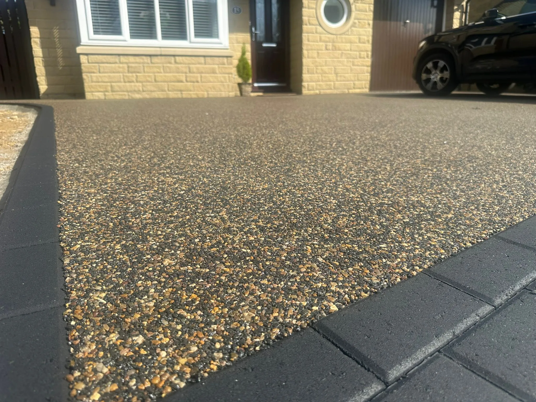 Completed premium amber resin bound driveway at a Manchester home