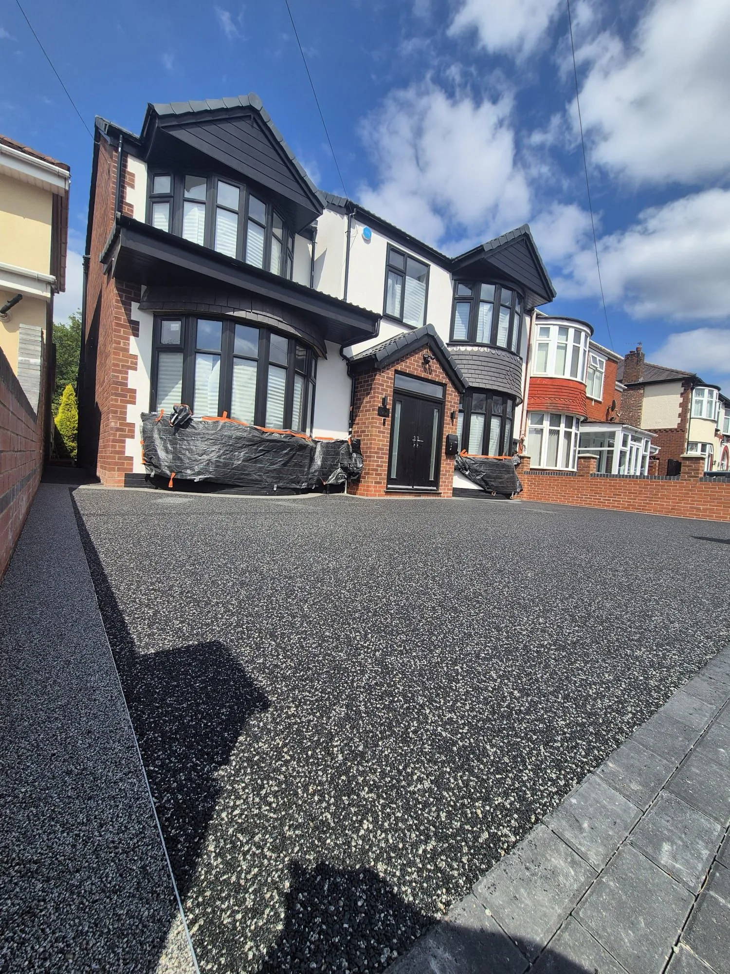 Black resin bound drive at detached home, Manchester