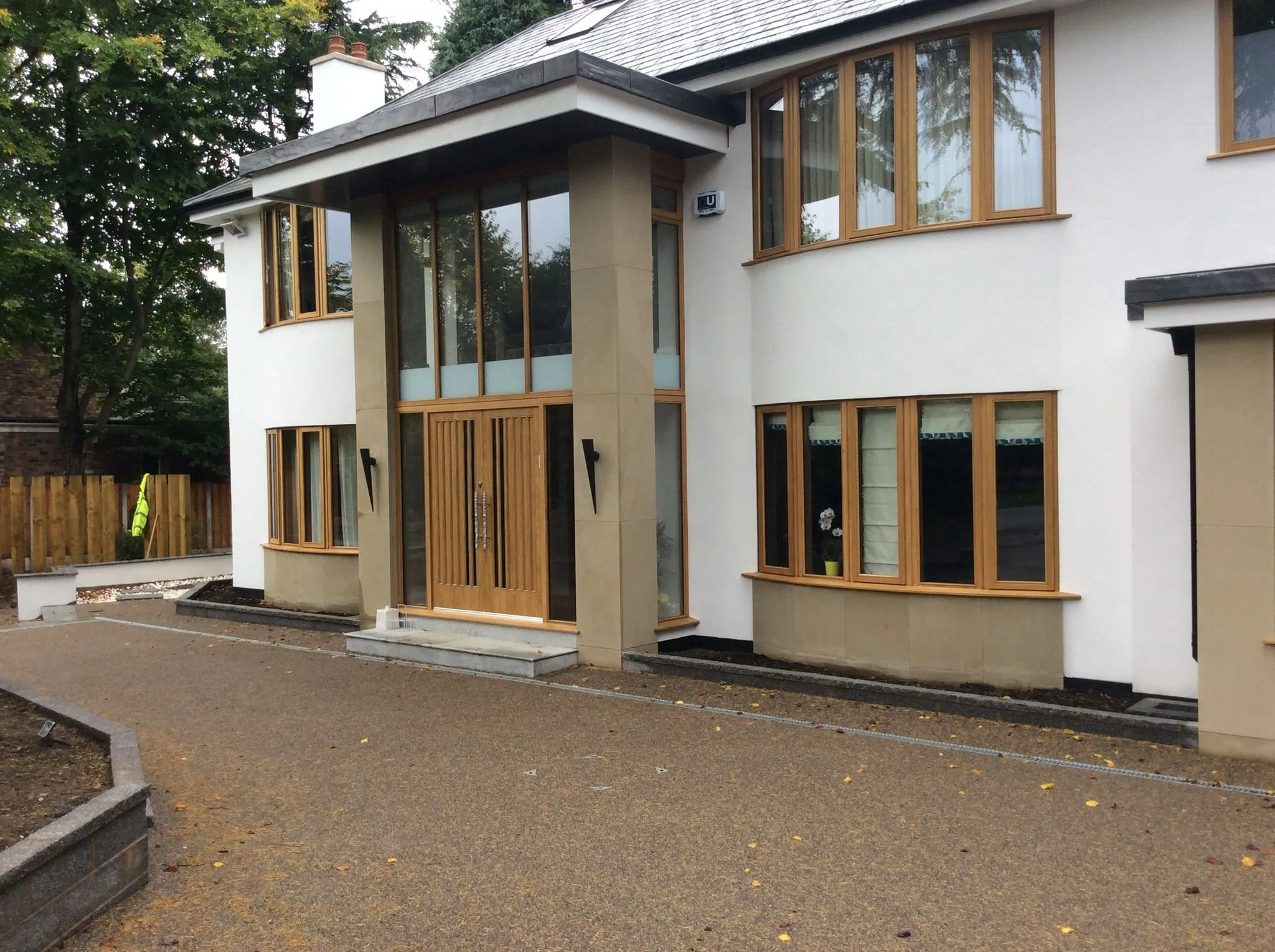 Bronze resin drive at contemporary home with oak porch