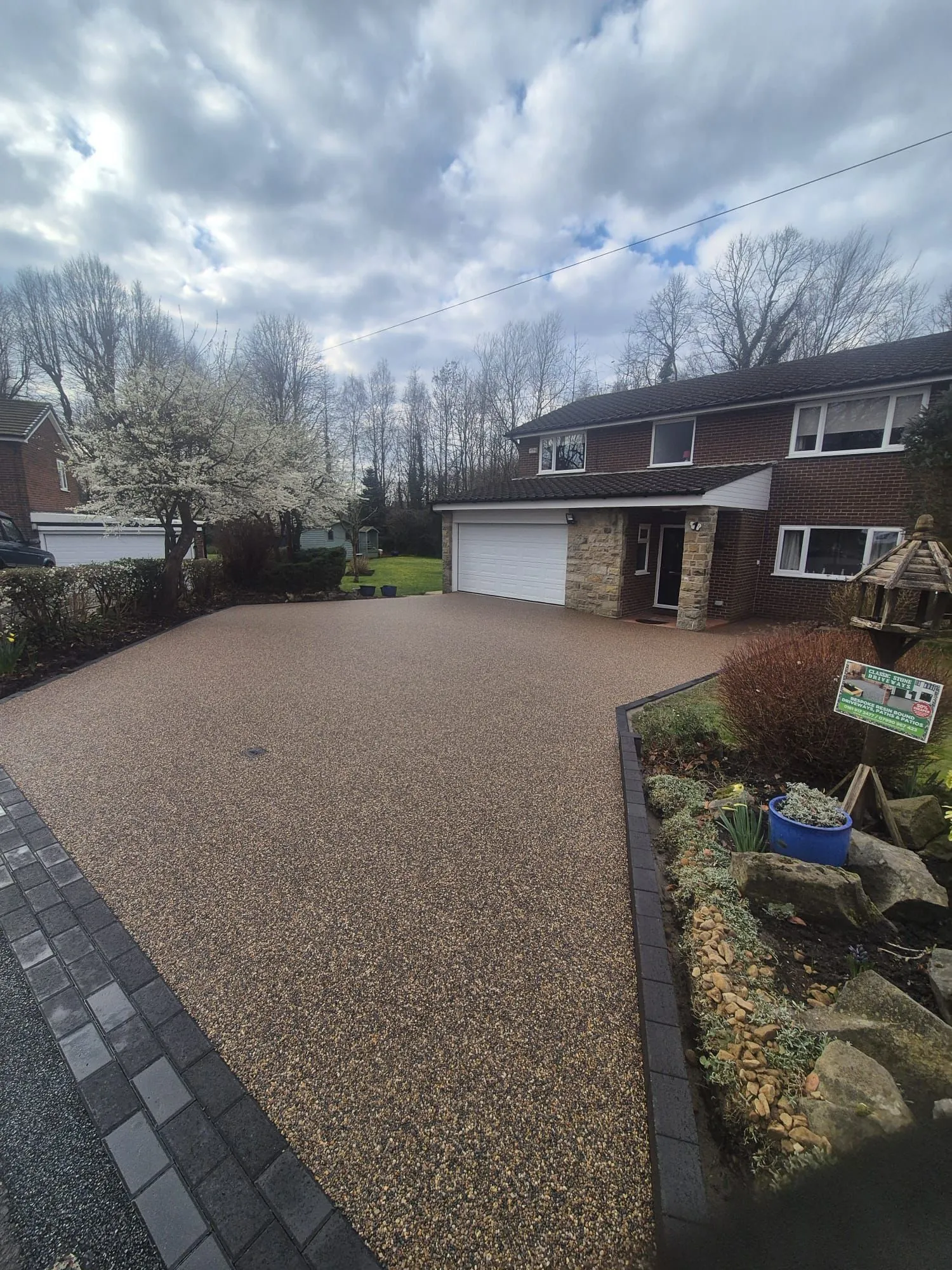 Bronze resin drive at detached home in woodland setting