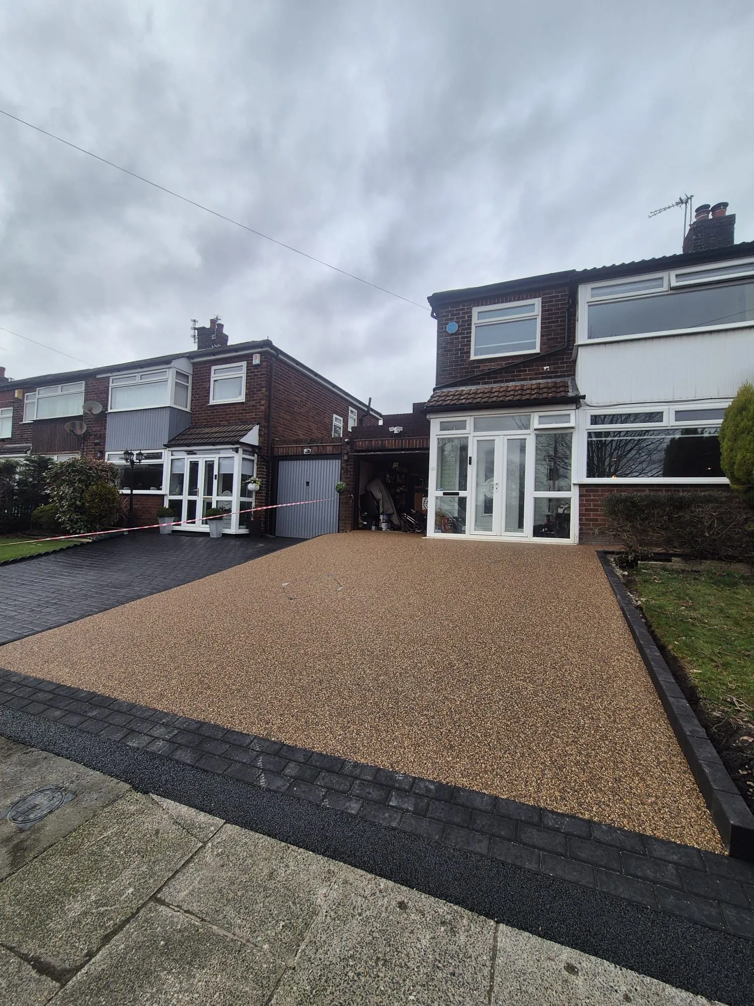 Bronze resin drive at semi-detached home with porch
