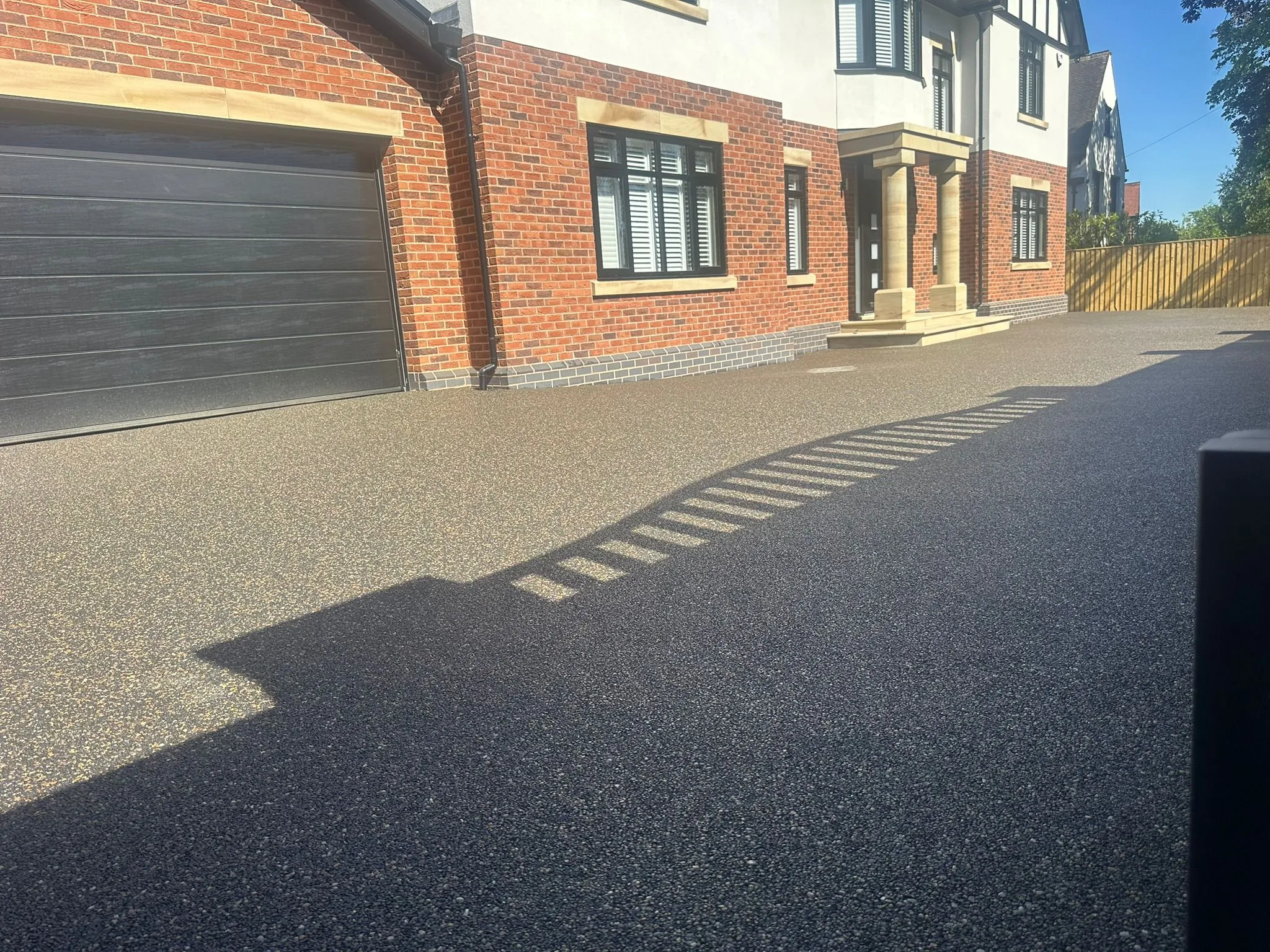 Bronze resin driveway at large home with garage, Manchester