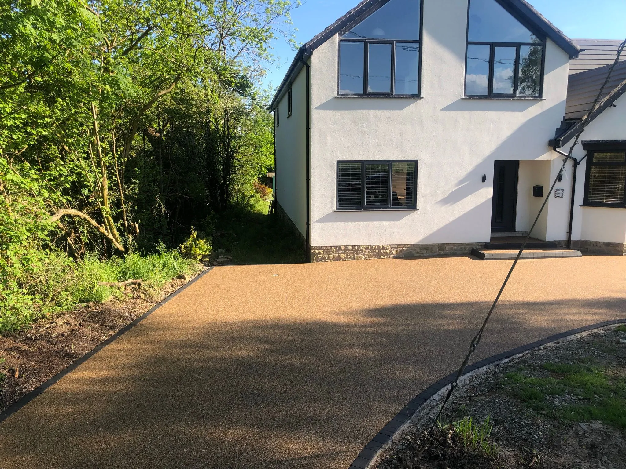 Bronze resin driveway at white rendered semi, Manchester