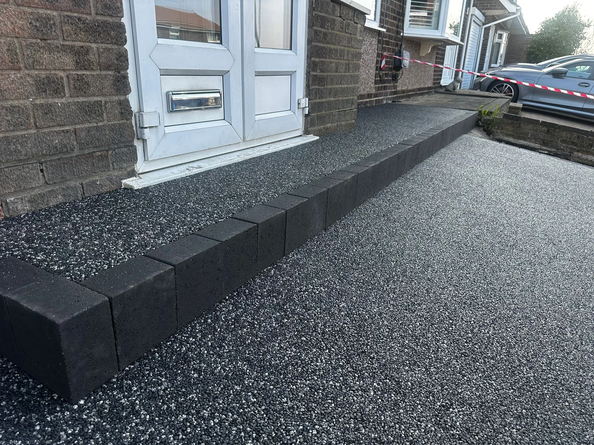 Charcoal resin drive with block-edged step