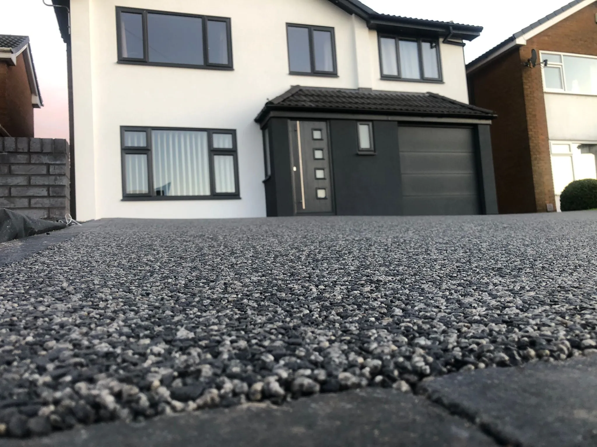 Charcoal resin drive, low angle view at new build