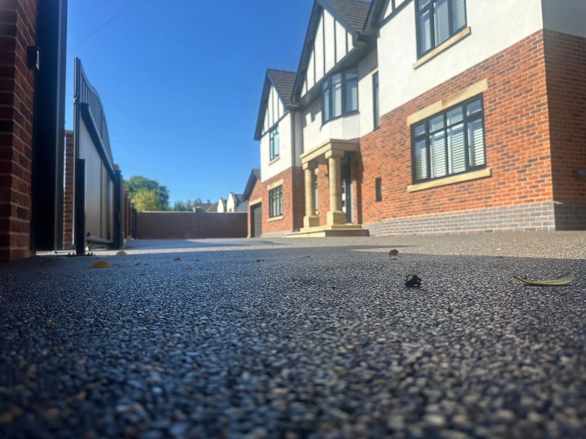 Charcoal resin drive, low angle view at Tudor home