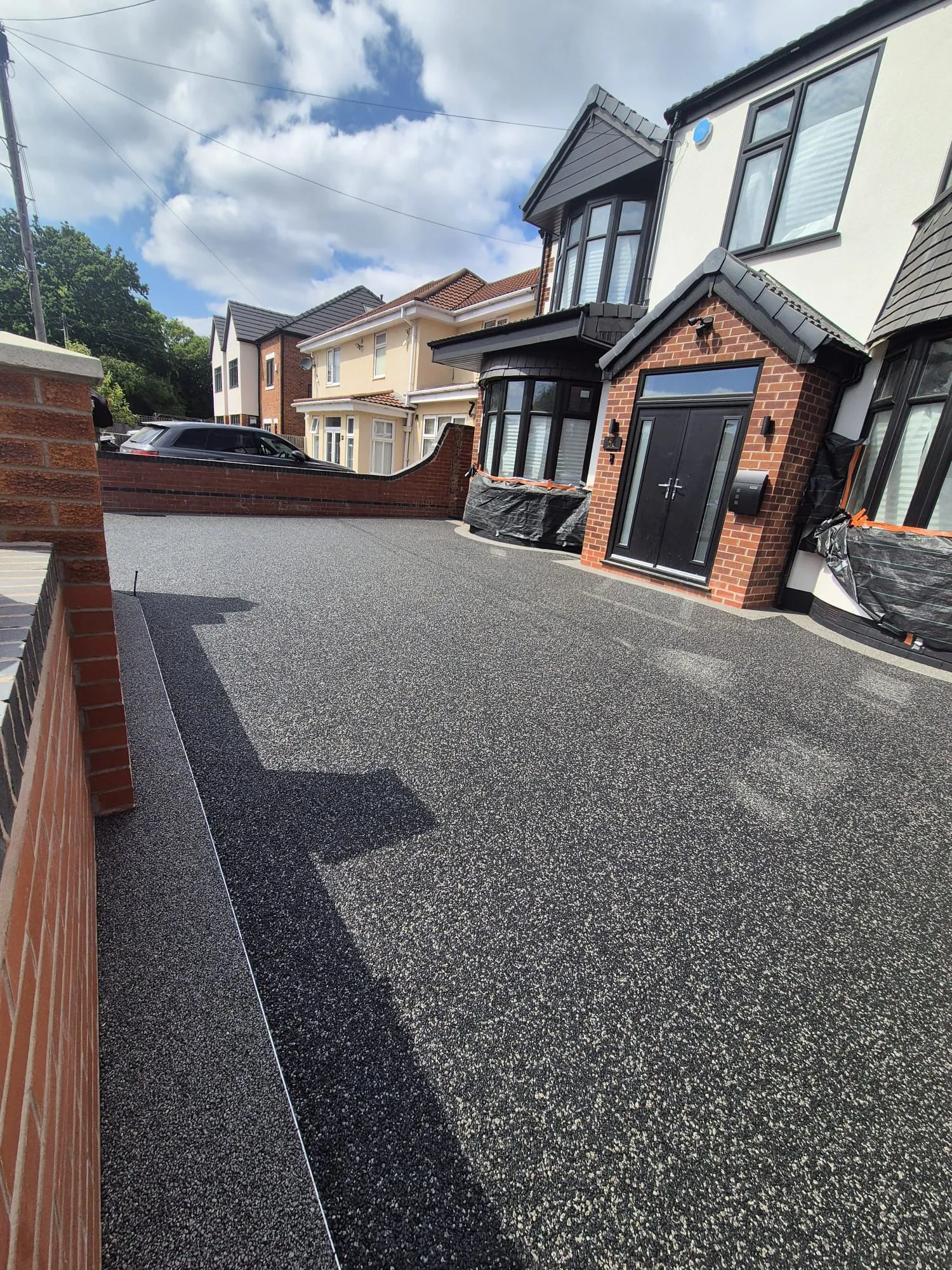 Charcoal resin drive at modern semi, side view, Manchester