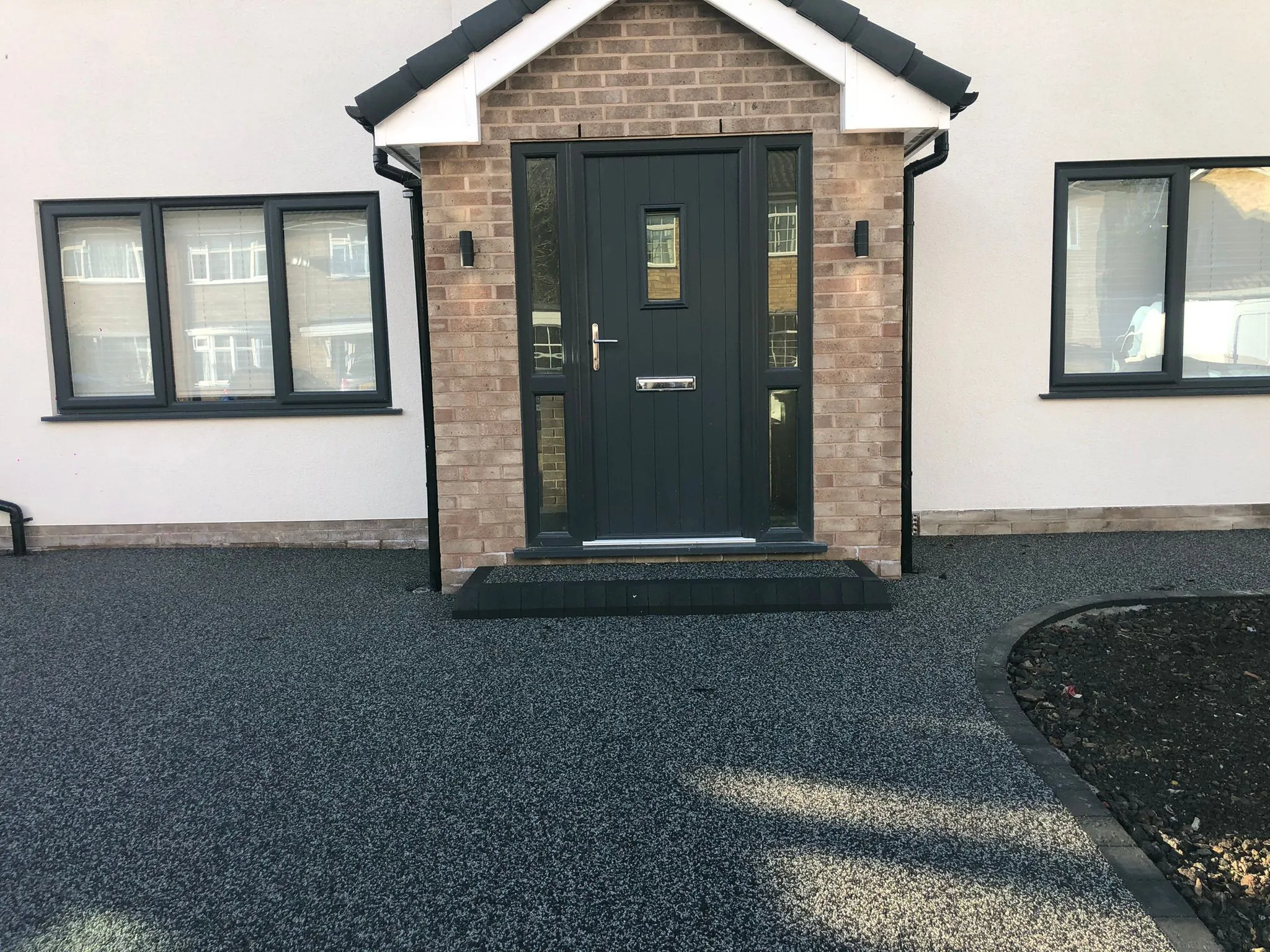 Charcoal resin drive with porch step and grey front door
