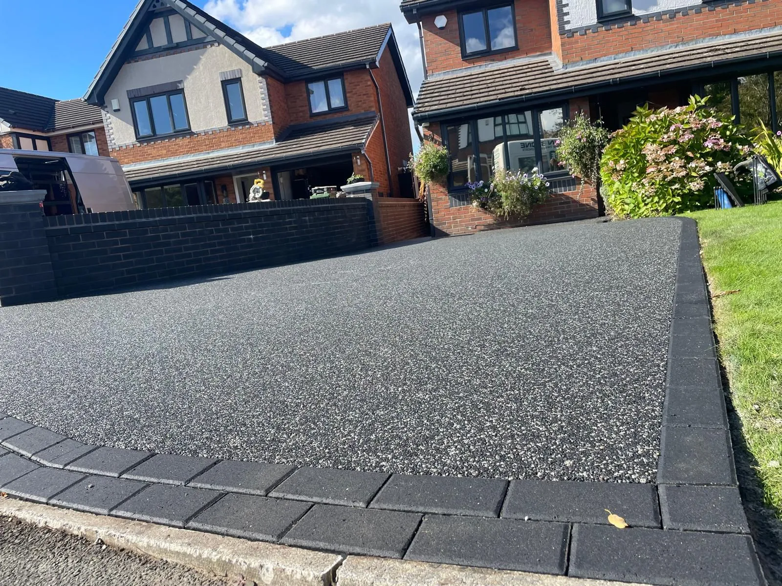 Charcoal resin sloped driveway installation, Manchester