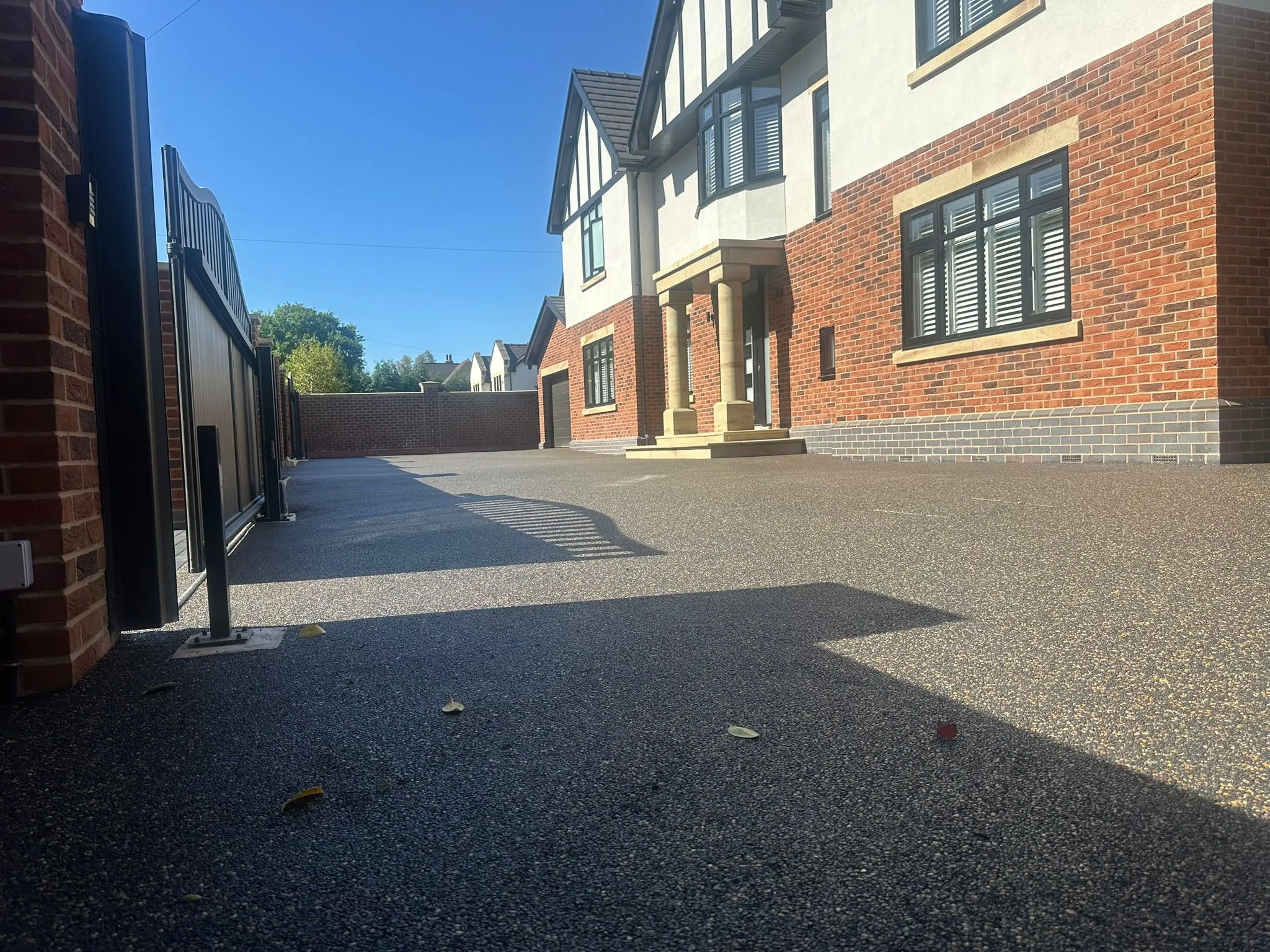 Charcoal resin drive at gated Tudor style home, Manchester