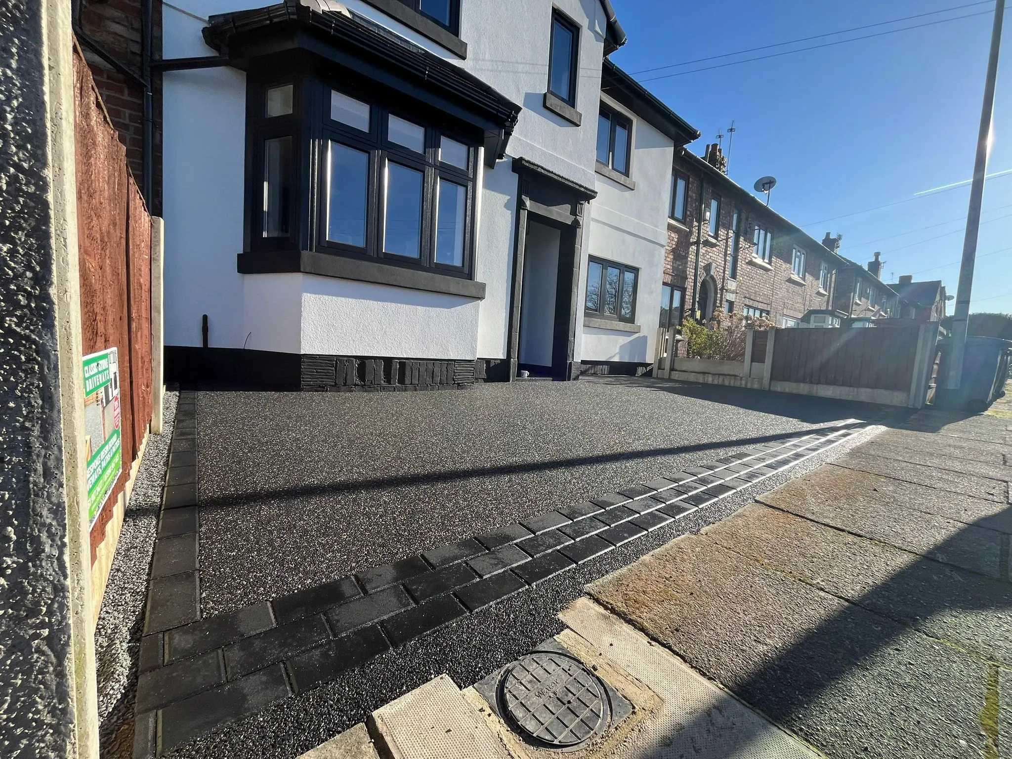 Charcoal resin drive at white rendered semi, Manchester