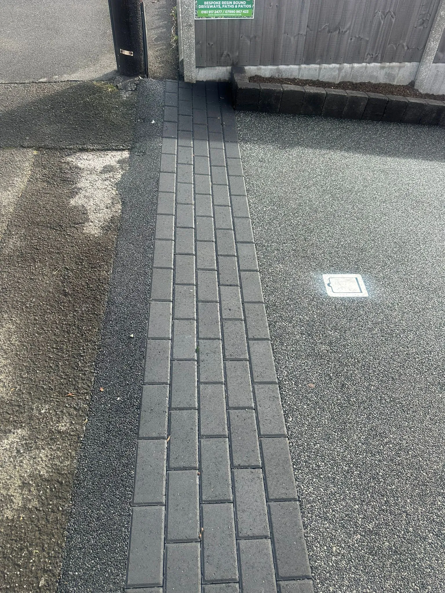 Charcoal resin driveway with block paved drainage channel