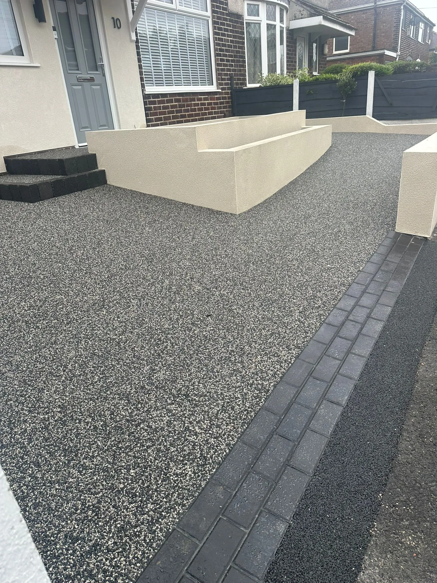 Charcoal resin driveway with cream wall border