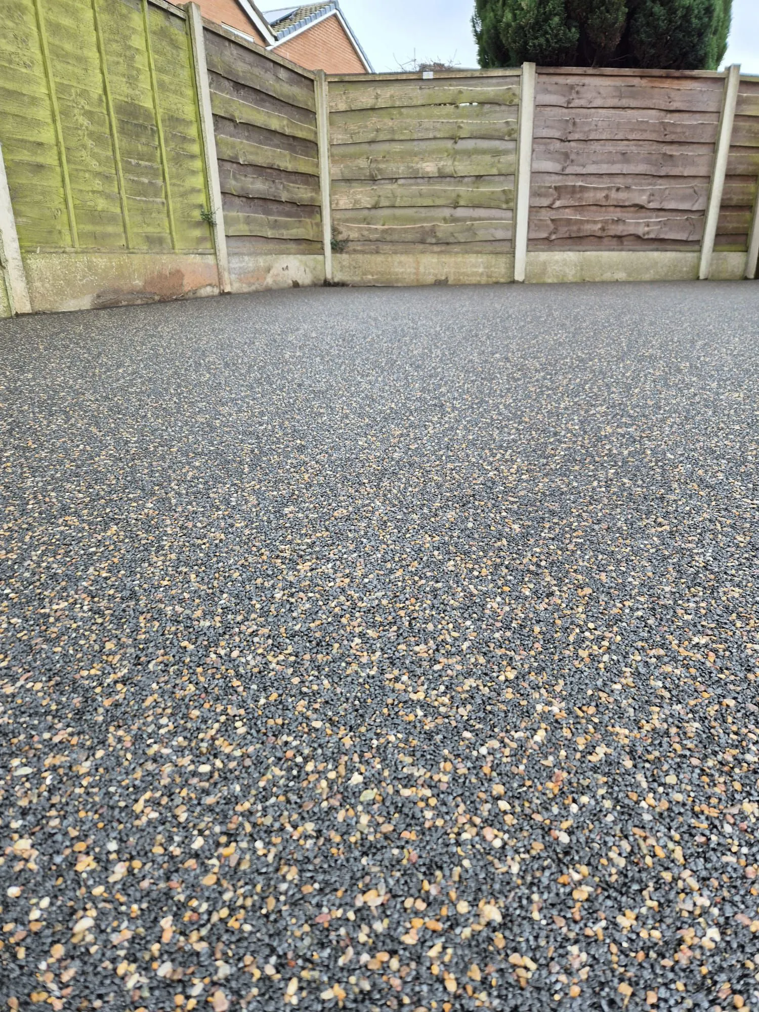 Charcoal resin driveway with garden close-up, Manchester