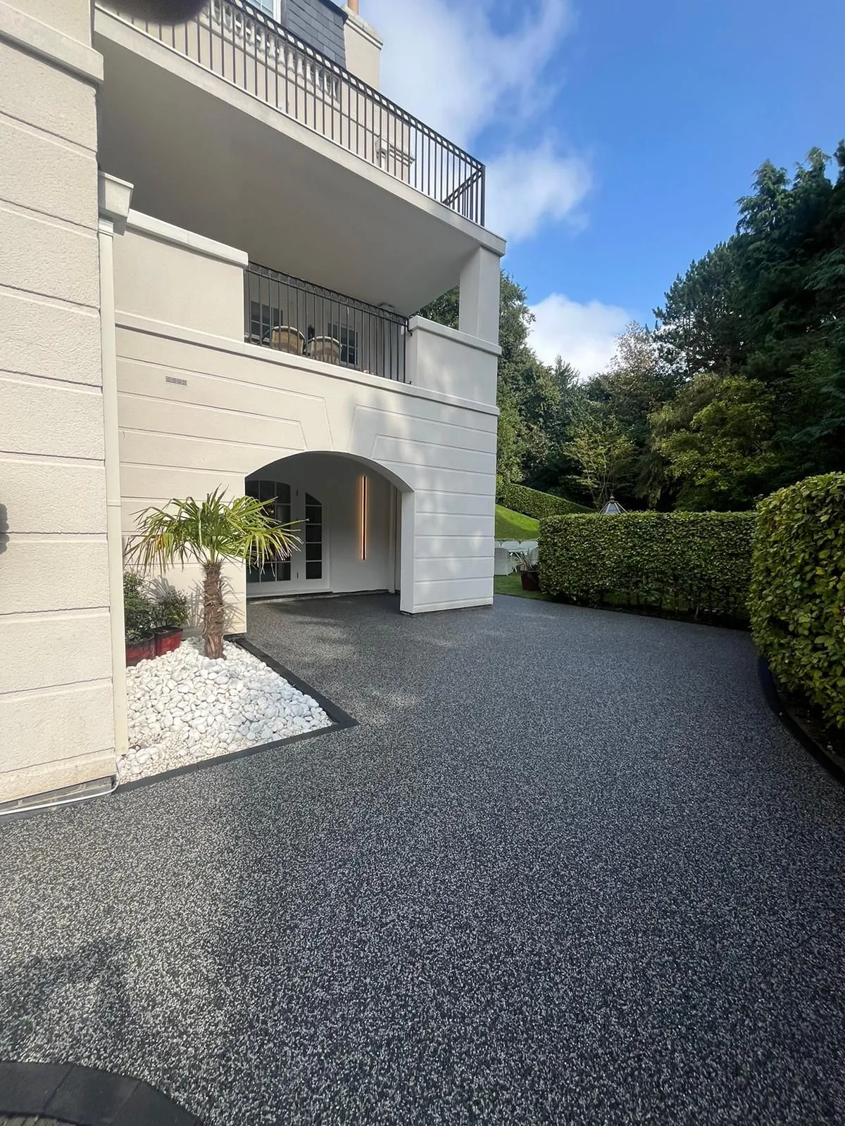 Charcoal resin driveway at white apartment block, Manchester