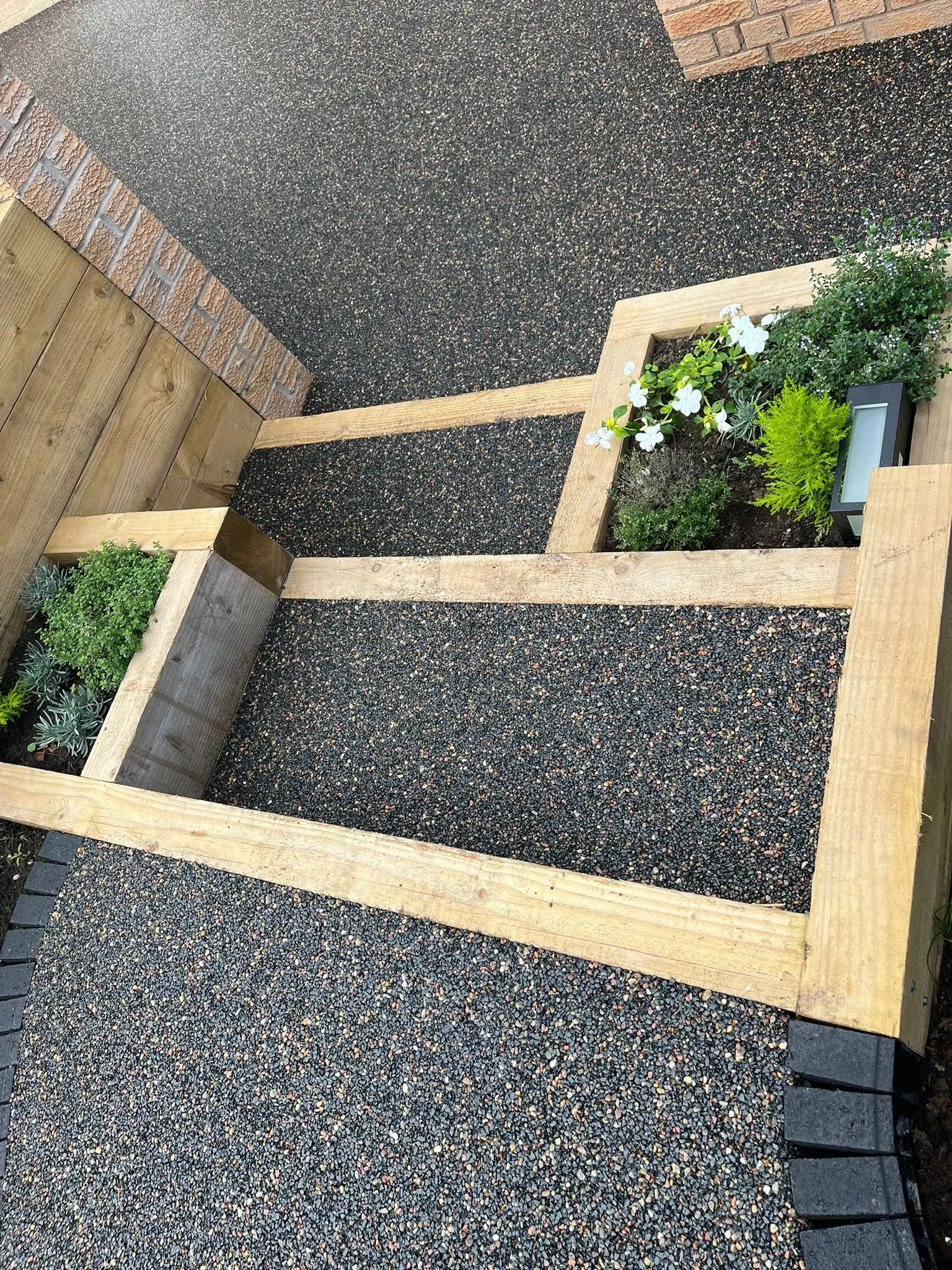 Charcoal resin path with sleeper planter beds
