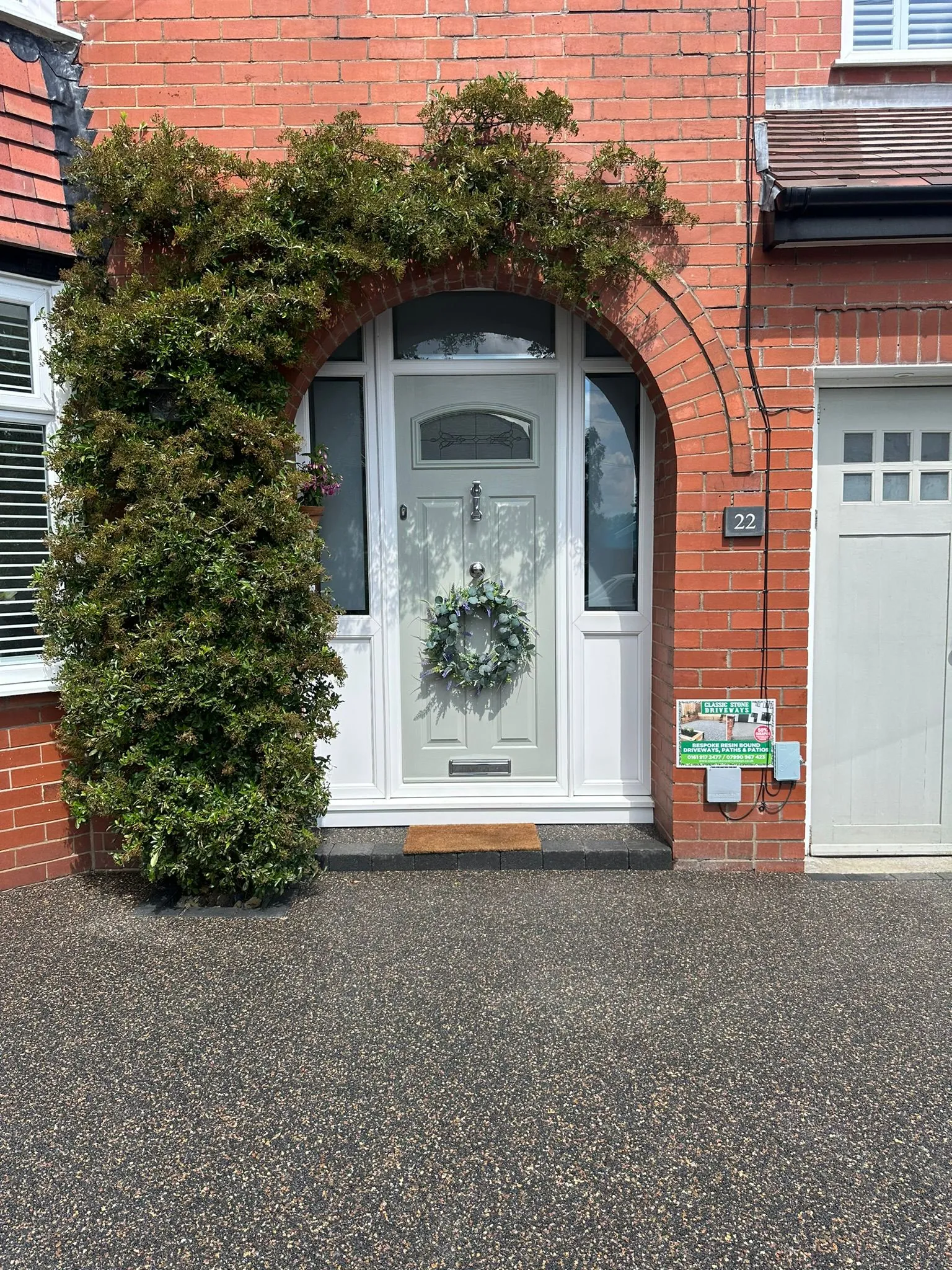 Golden resin driveway with arched porch entrance