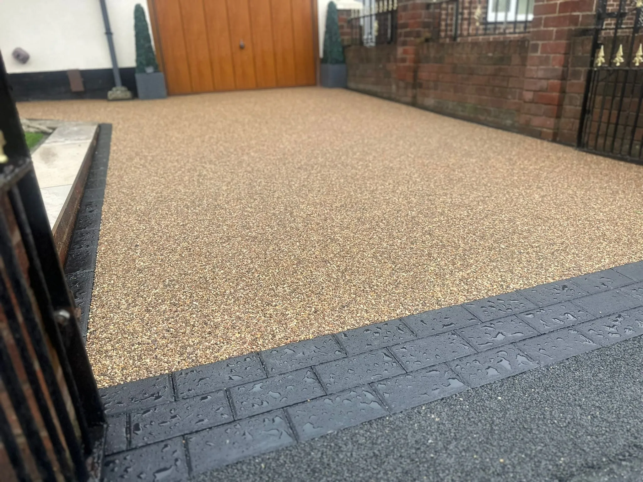 Golden resin driveway with gated oak garage, Manchester