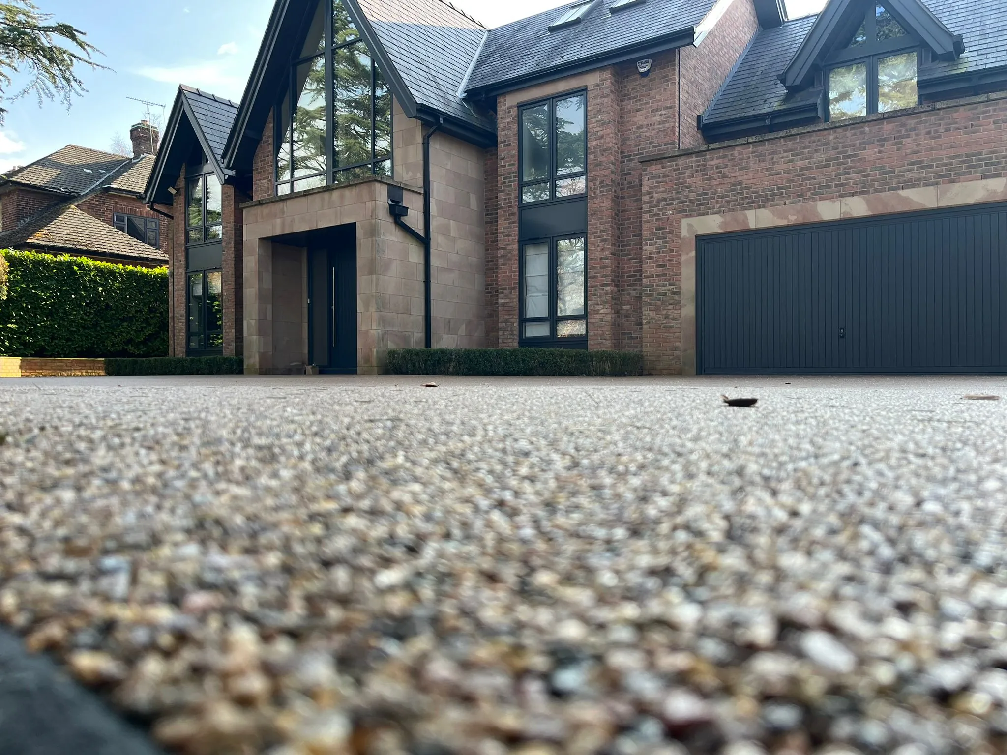 Grey resin driveway at modern barn style home, Manchester