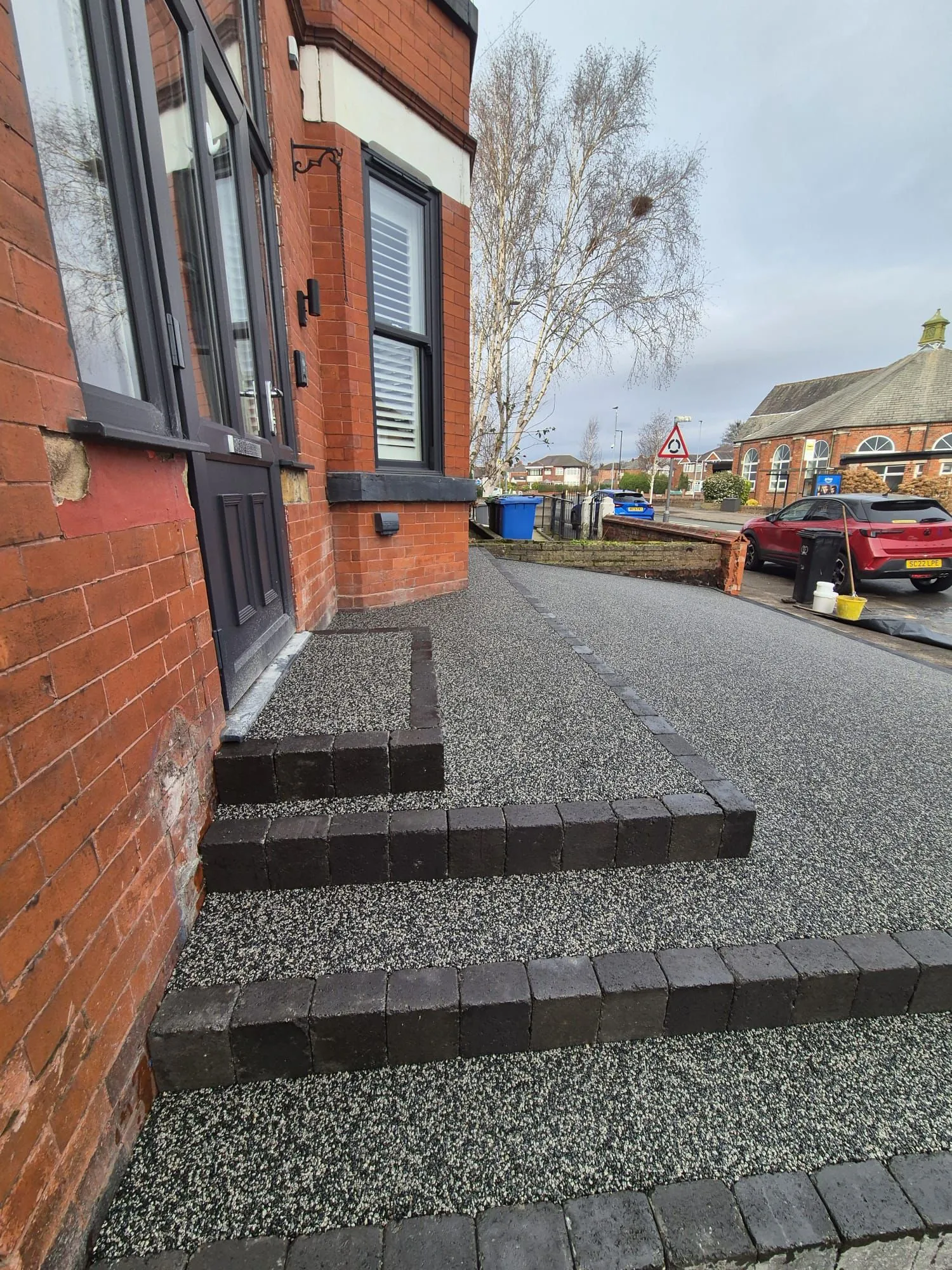 Grey resin driveway with red brick steps, Manchester