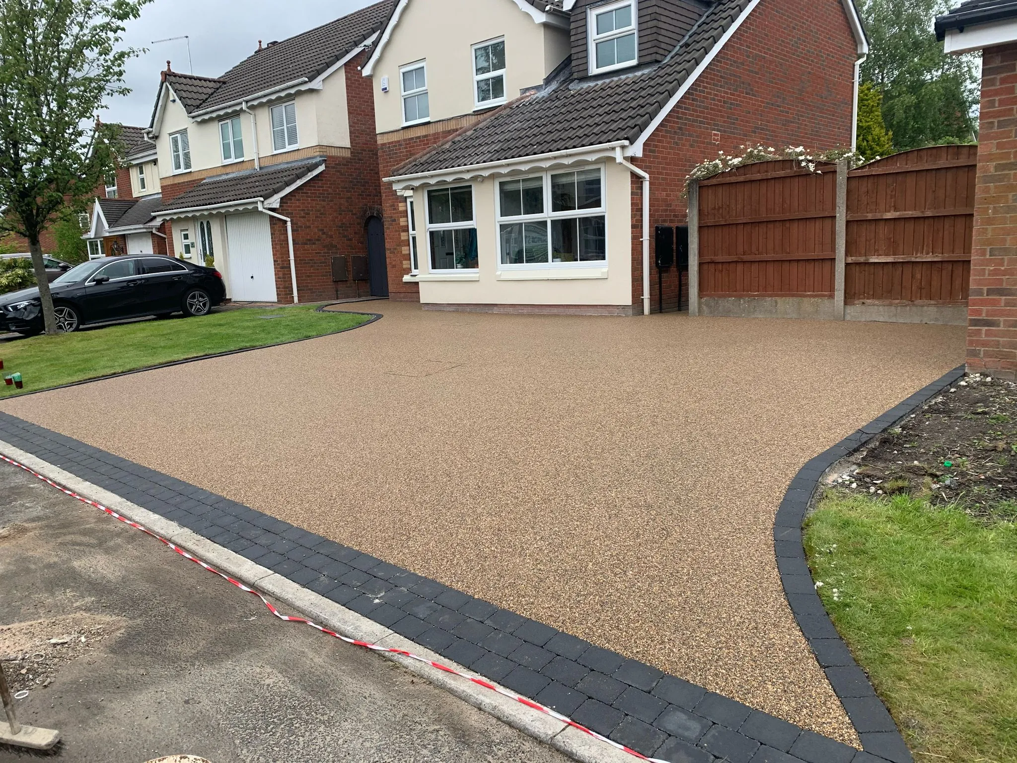 Honey resin drive at detached white rendered home