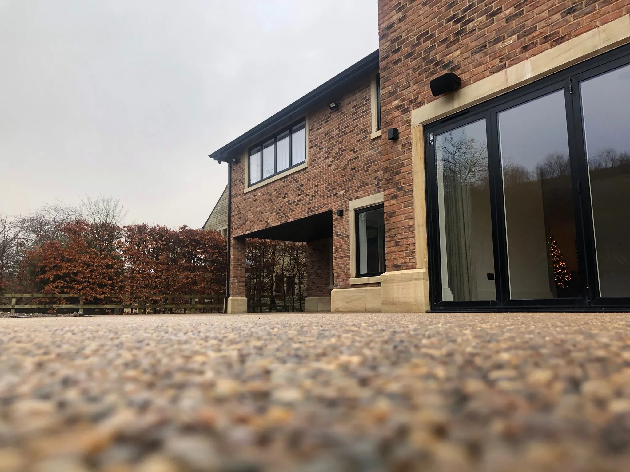 Multi-tone resin drive at modern home, low angle view