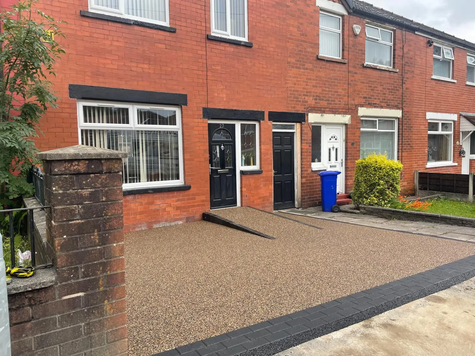 Russet resin drive with ramp at red brick terraced house