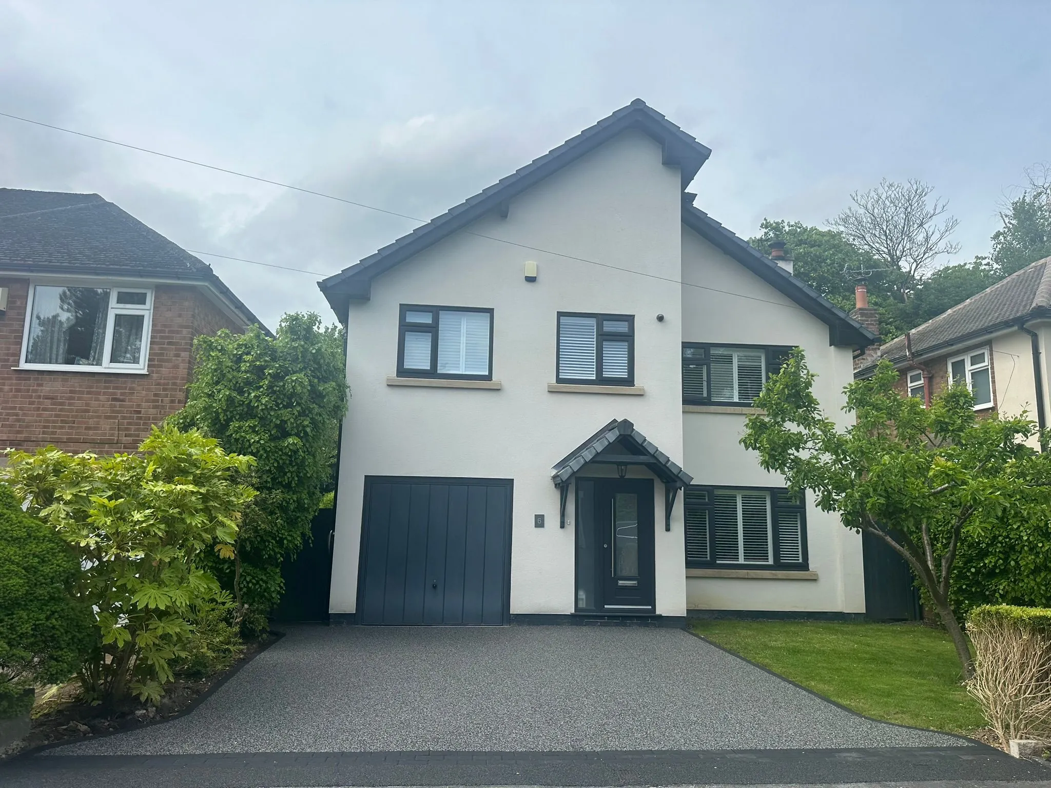 Silver grey resin drive at white detached house, Manchester