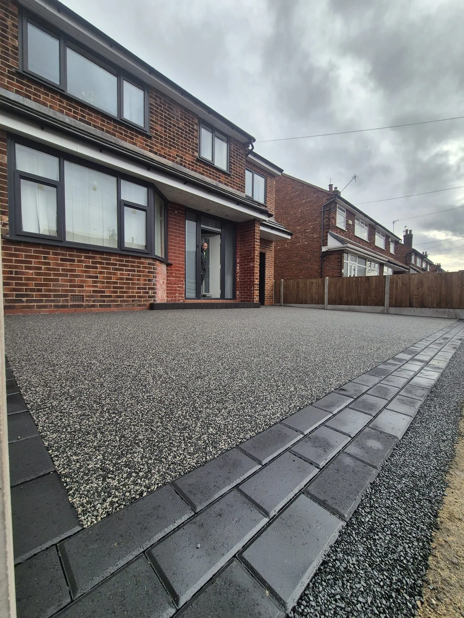 Silver grey resin driveway at red brick semi-detached, Manchester