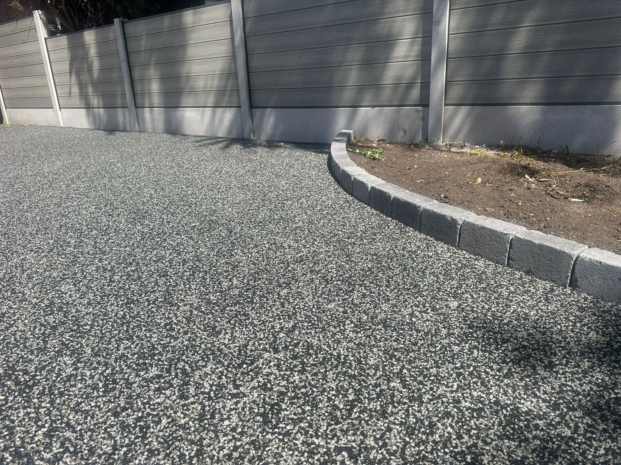 Silver resin drive with cobble edging and fence