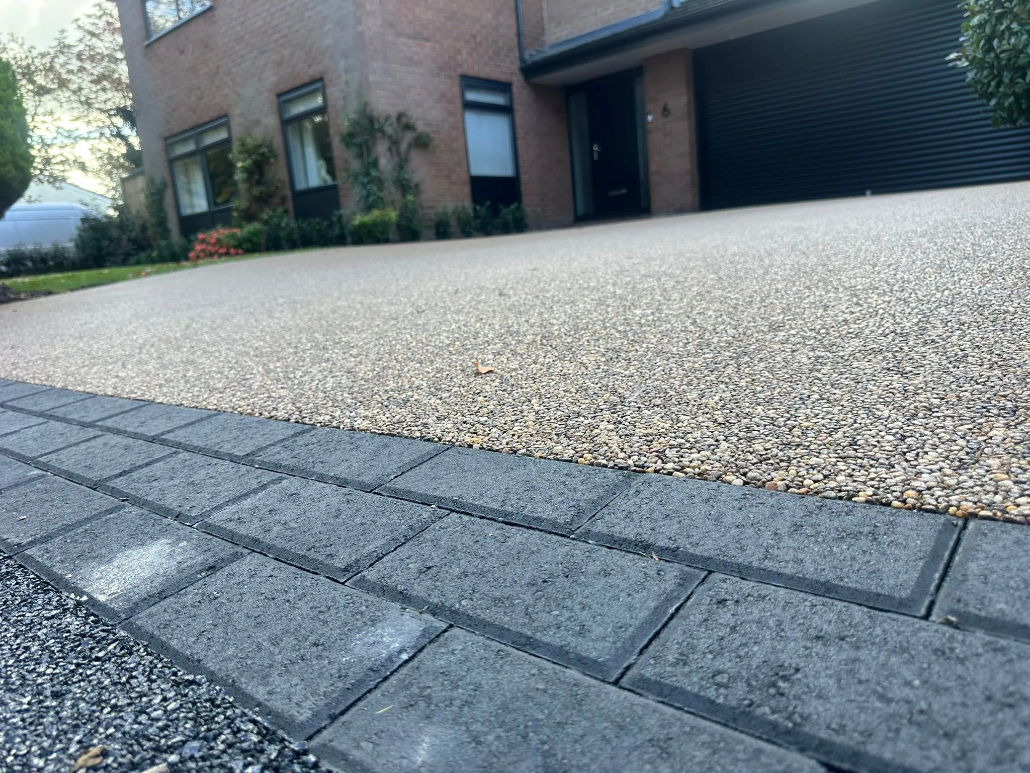 Silver resin driveway with modern block paved edging, Manchester