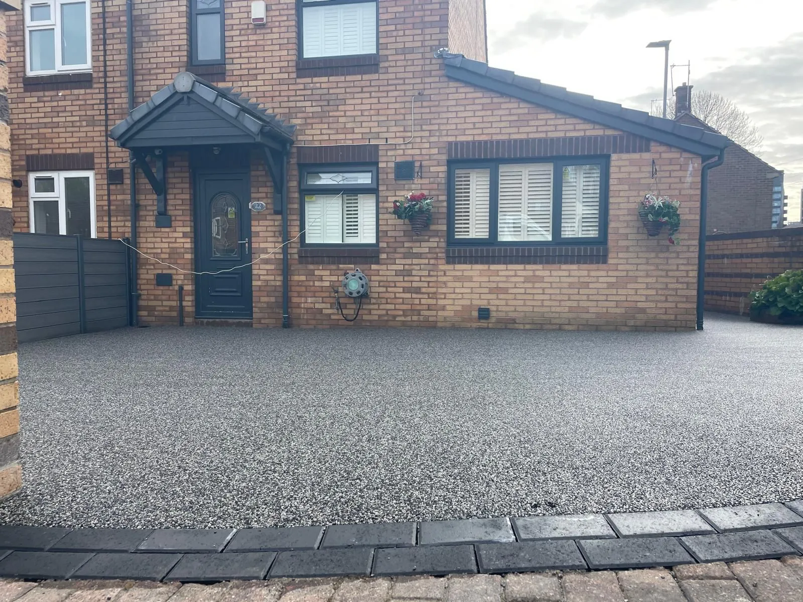 Silver resin driveway at semi-detached house with porch, Manchester