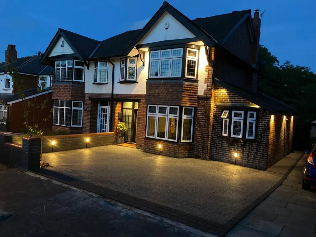 Silver resin driveway at Victorian home with evening lights, Manchester