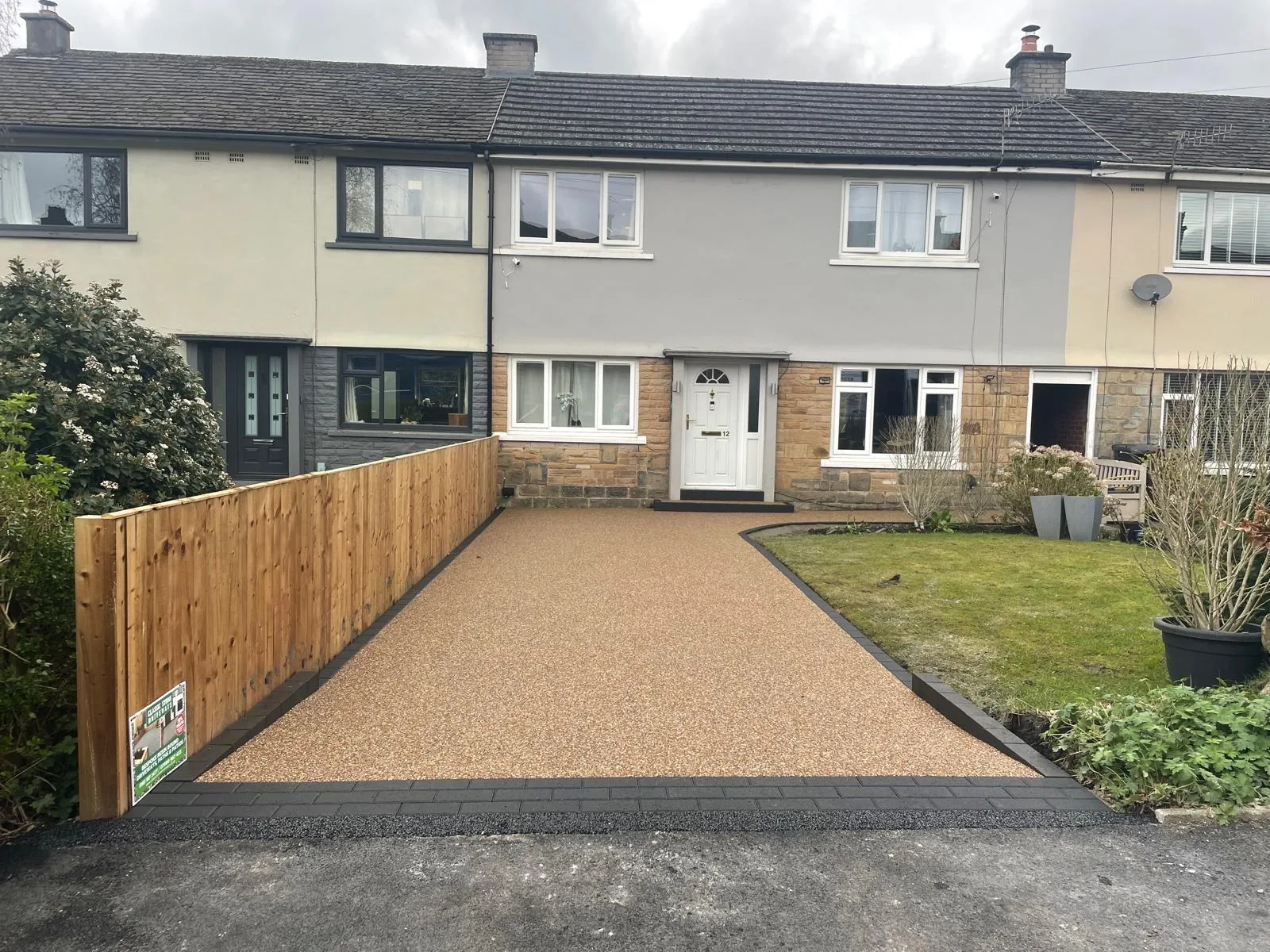 Brown resin bound driveway with timber fence at a semi, Manchester