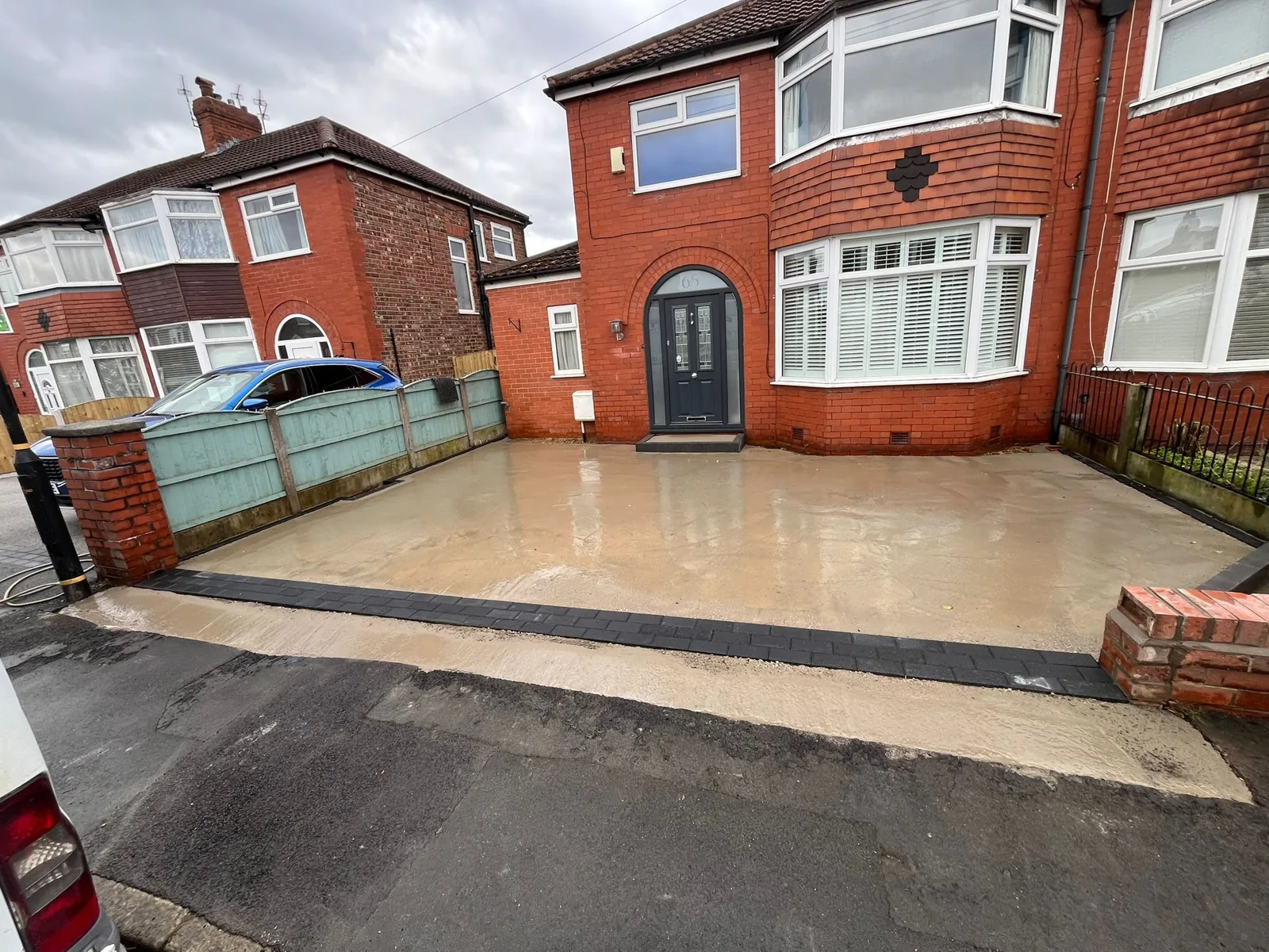 Brown resin driveway at a detached bay-window home, Manchester
