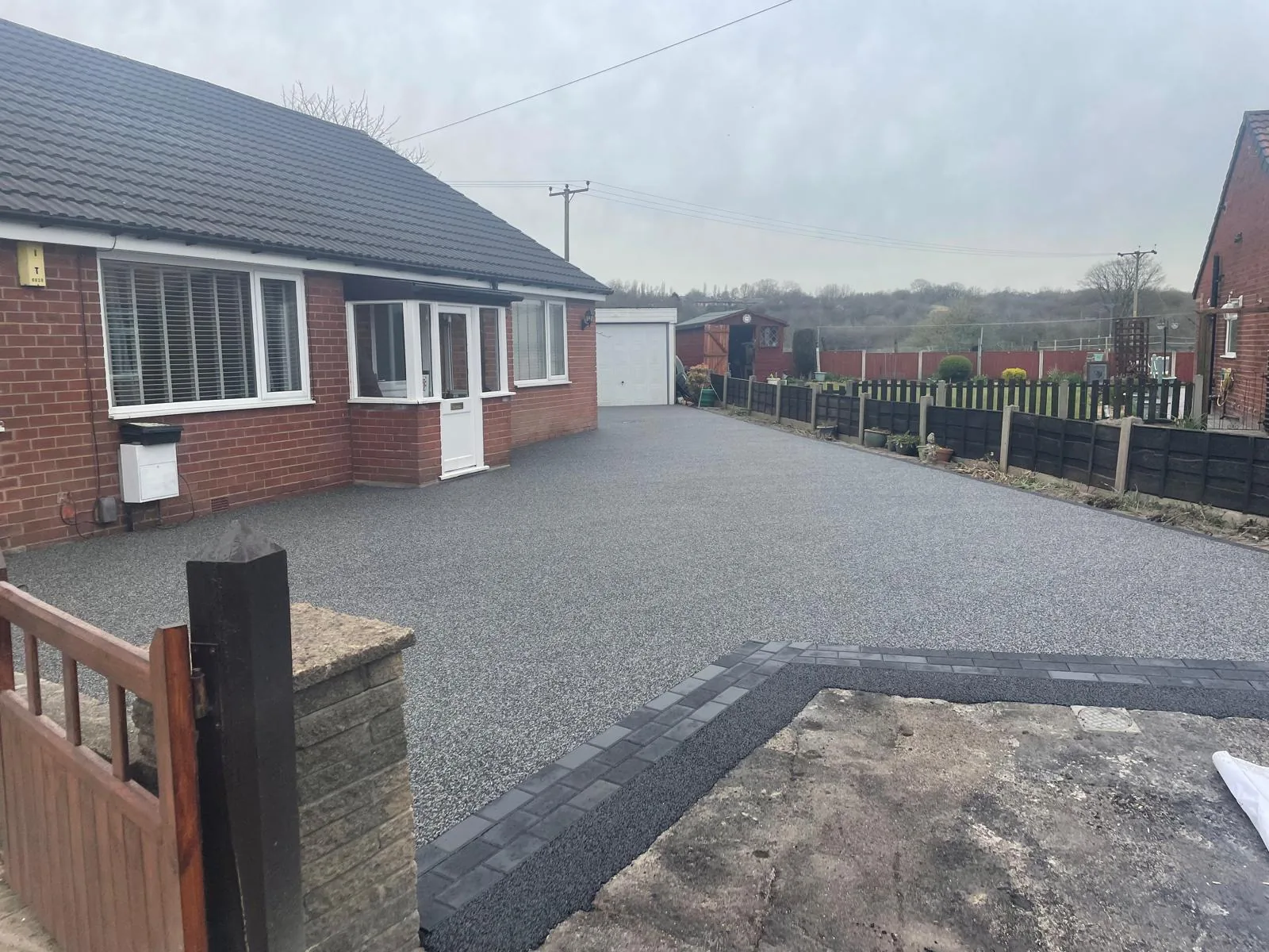 Charcoal resin bound driveway at a bungalow with garage, Manchester