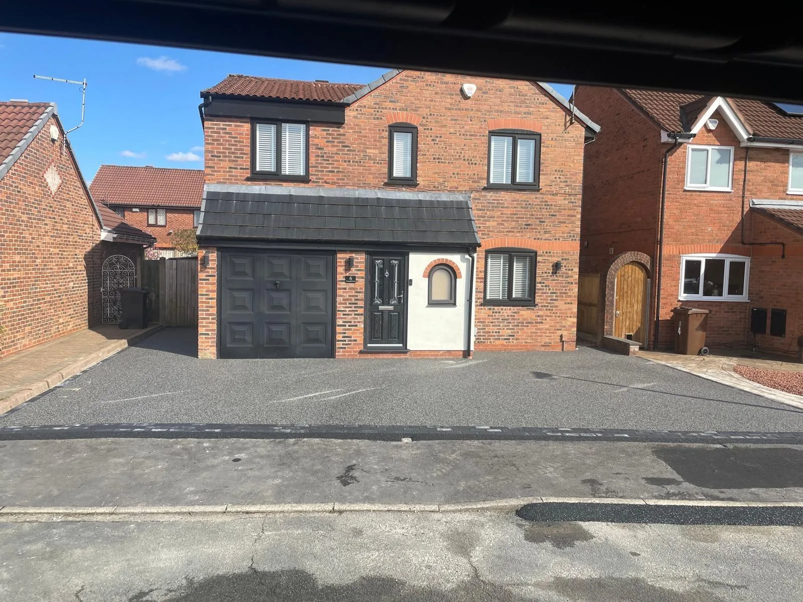 Charcoal resin driveway with block-paved border at a detached home, Manchester