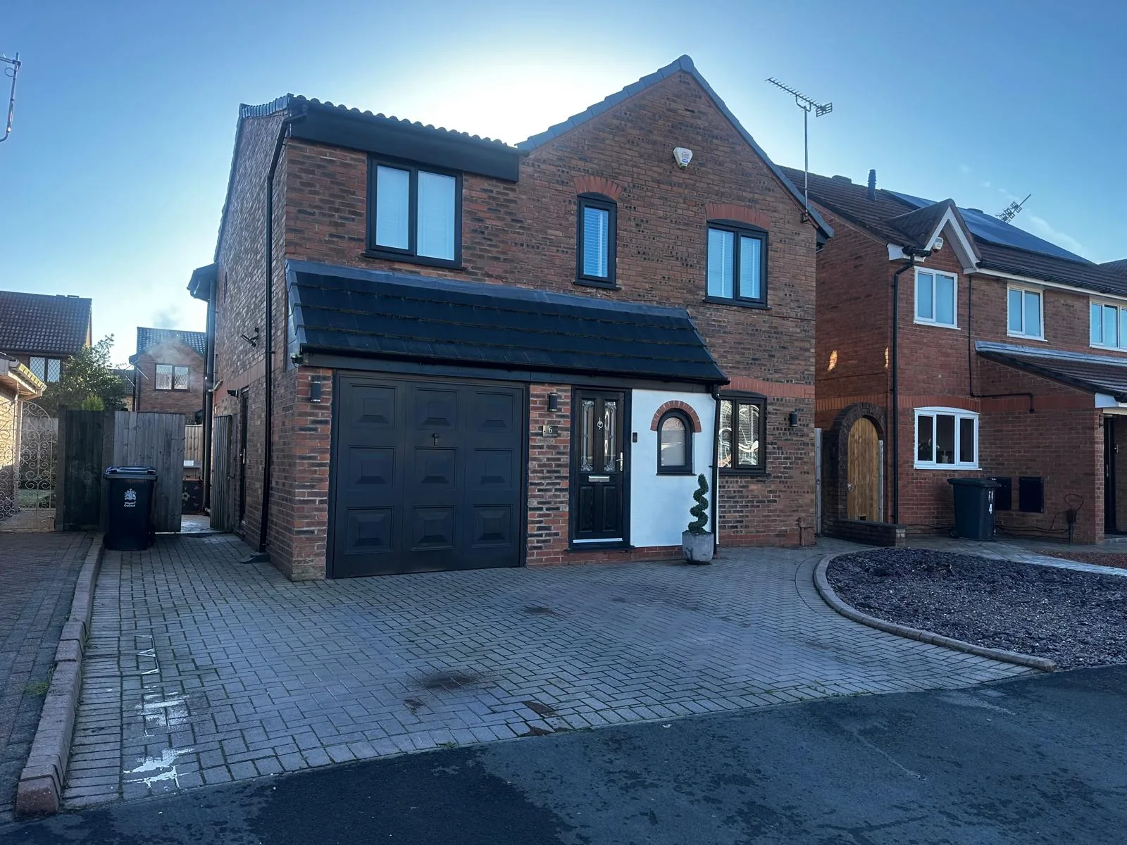 Charcoal resin driveway with block paving at a new-build detached home, Manchester