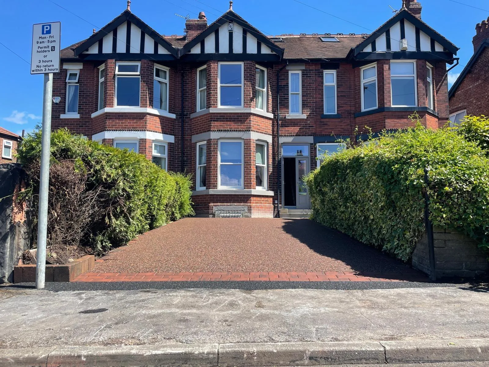 Copper-brown resin driveway at a mock-Tudor semi-detached home, Manchester