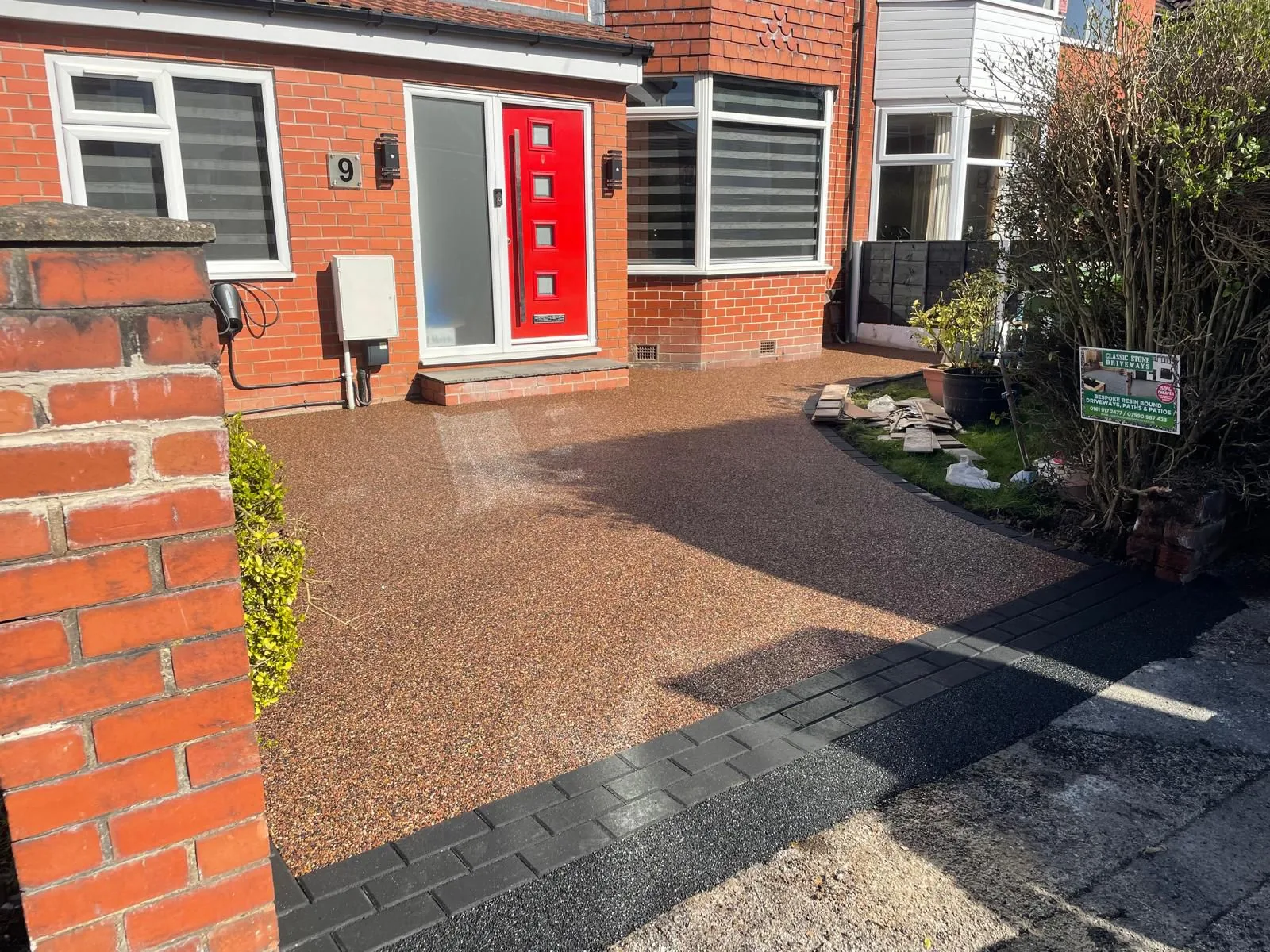 Copper resin bound driveway with charcoal border and red door, Manchester