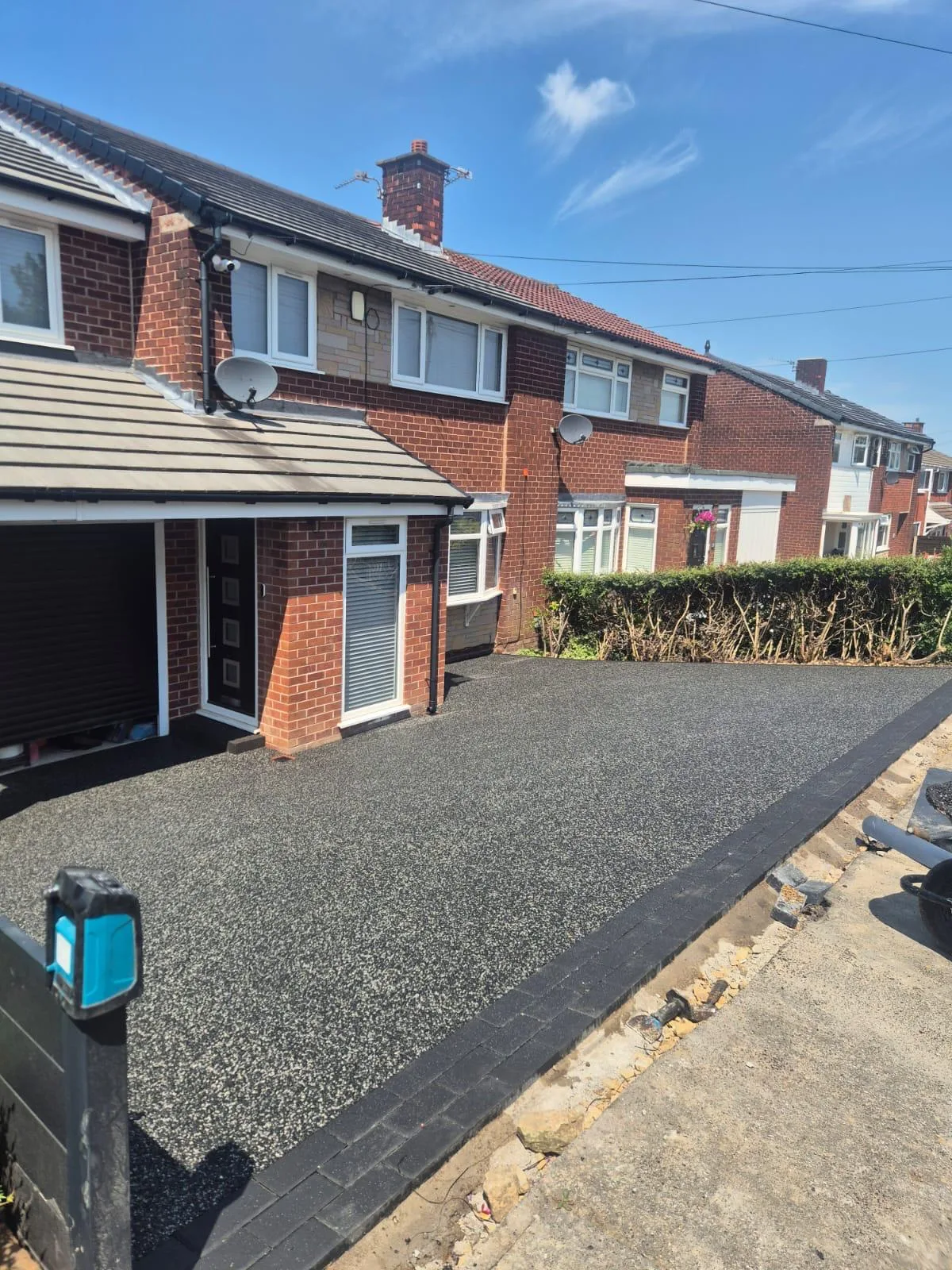 Eclipse resin driveway finished with a charcoal block paved border in Dukinfield