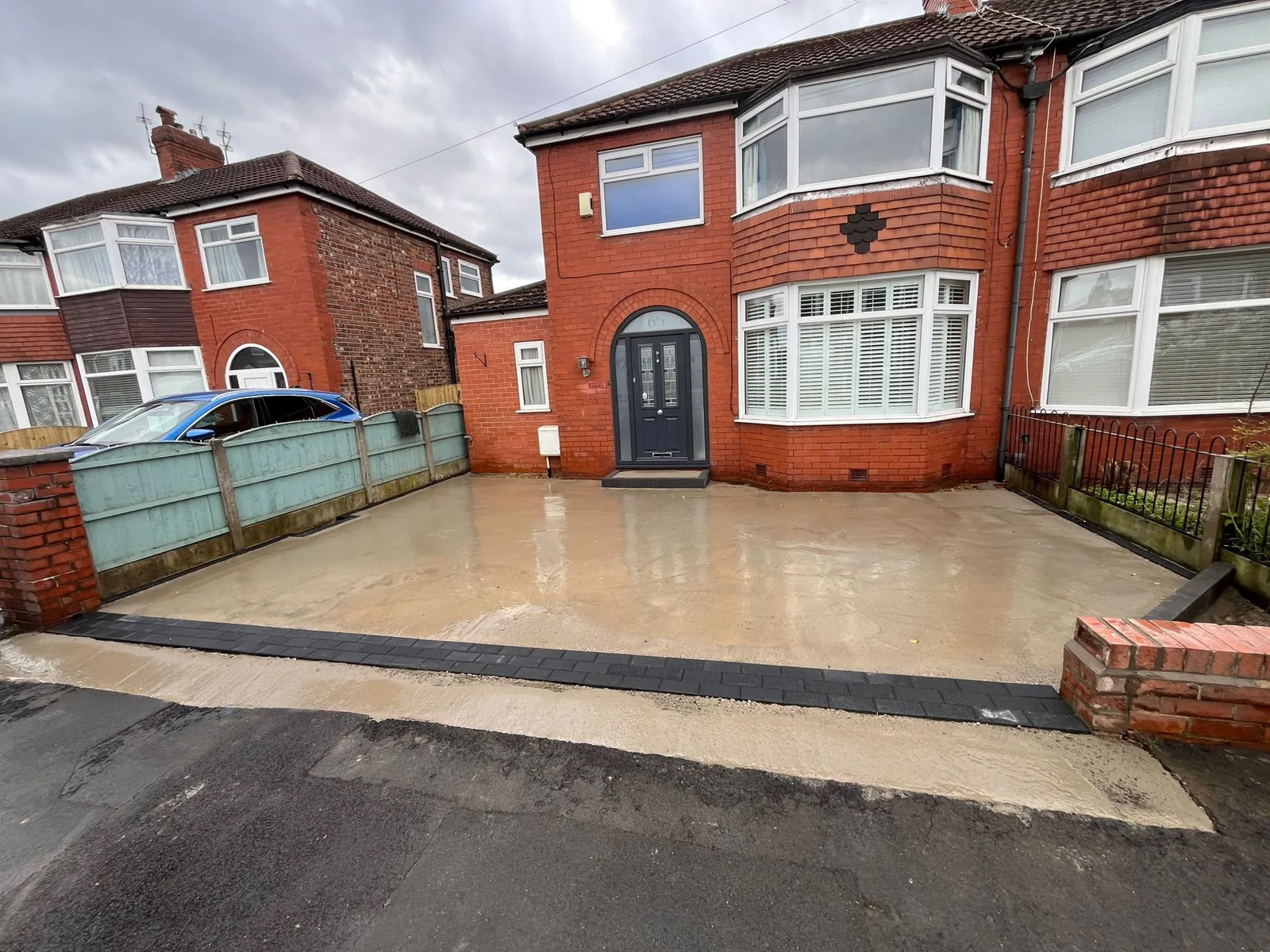 Golden-brown resin driveway at a semi-detached home, Manchester