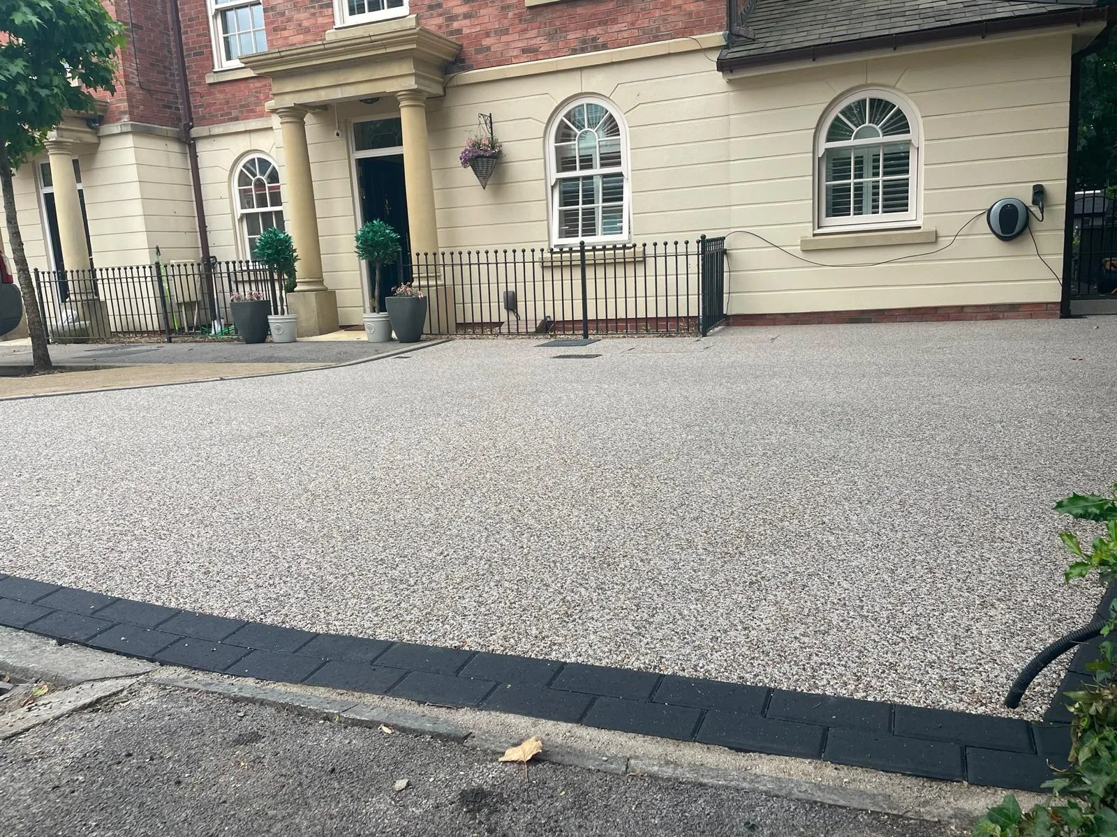Pearl gold resin bound driveway sweeping across a period frontage in Astley