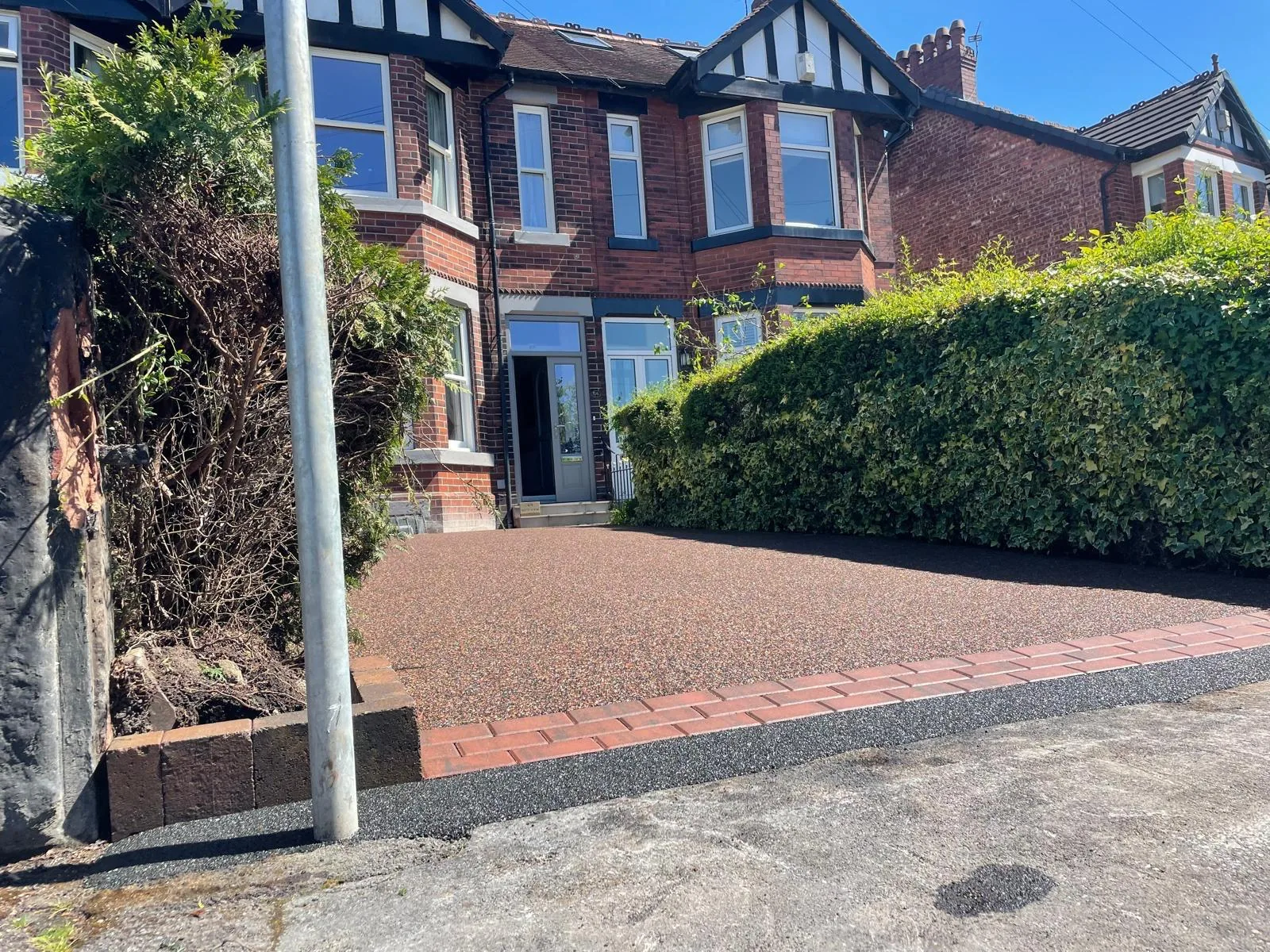 Red-brown resin driveway with block-paved border at a semi, Manchester