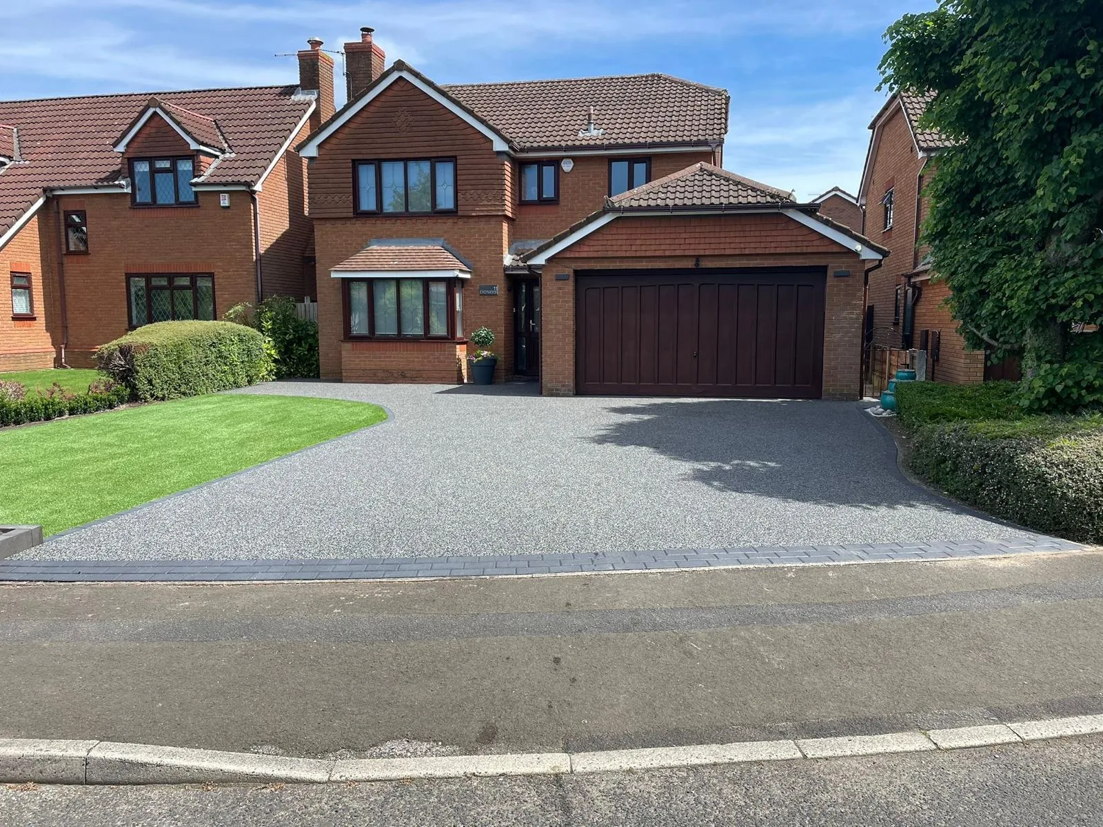 Silver resin bound driveway at a detached home with double garage, Manchester