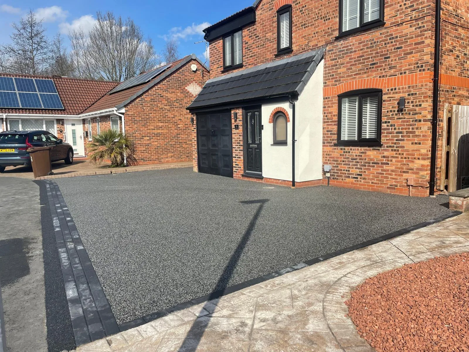 Silver resin bound driveway at a red-brick detached home, Manchester