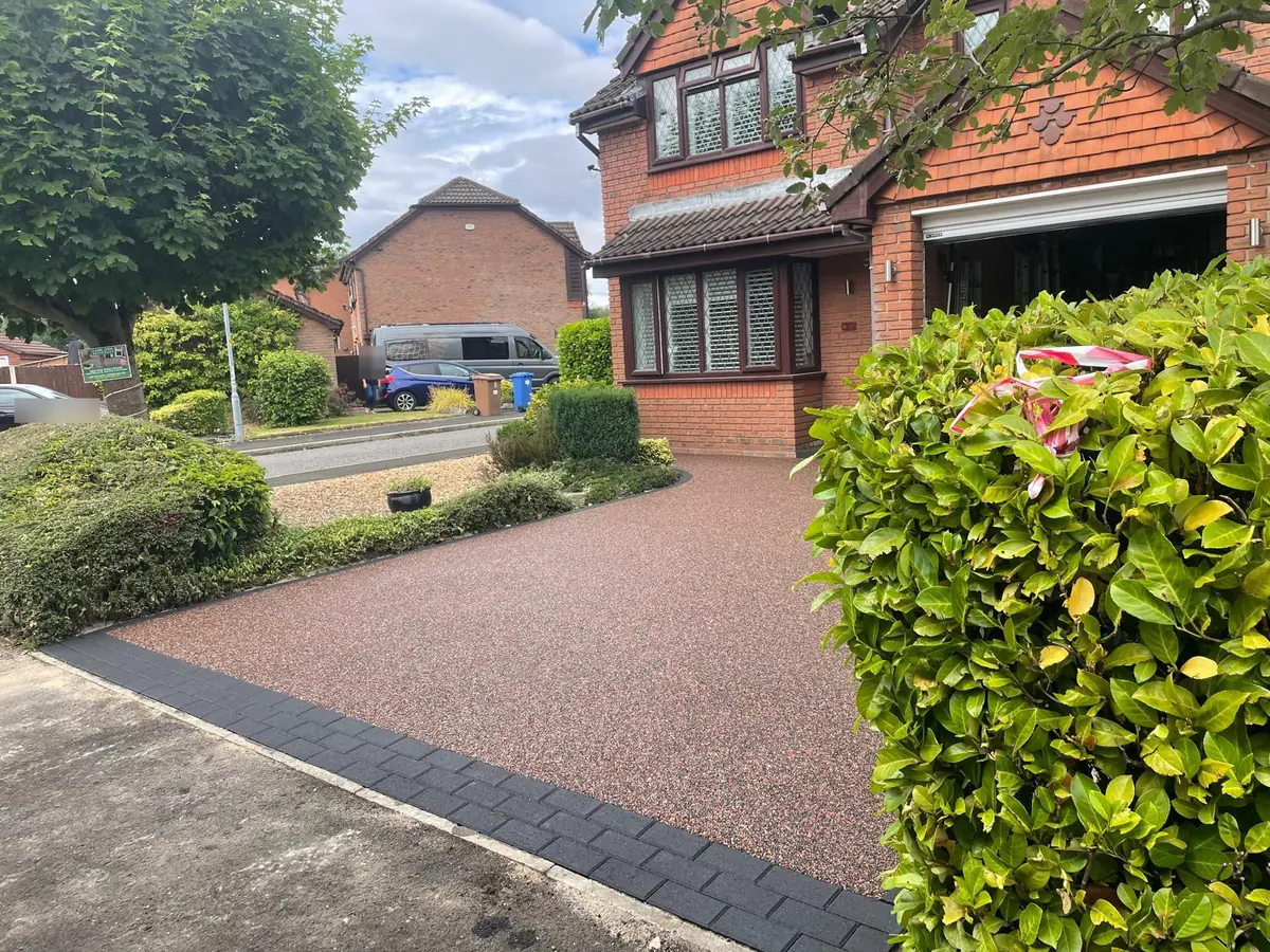 The Rosegarden resin driveway seen from the road, with a charcoal block apron at the entrance