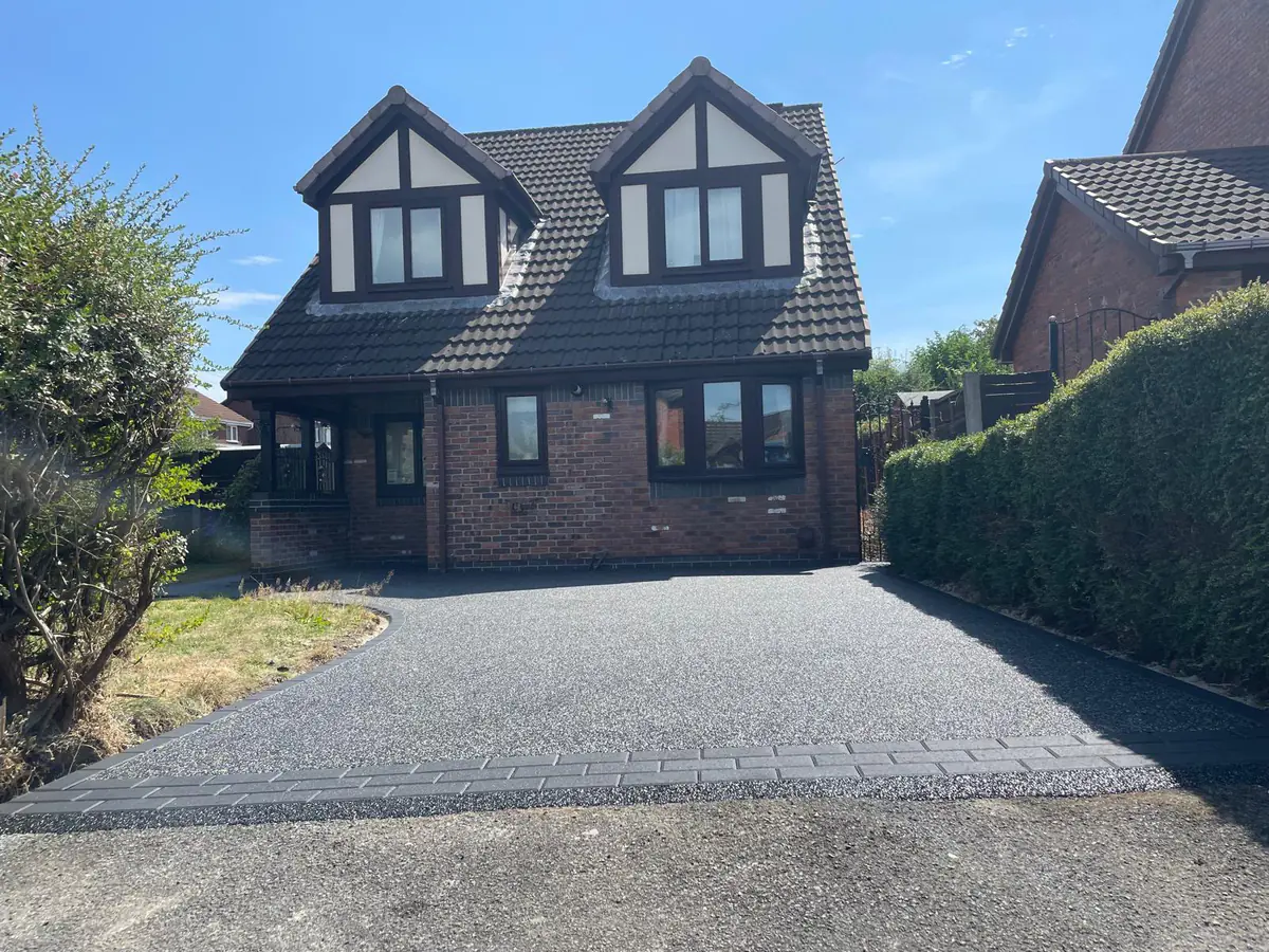 Black and silver resin bound driveway at a dormer home in Hyde