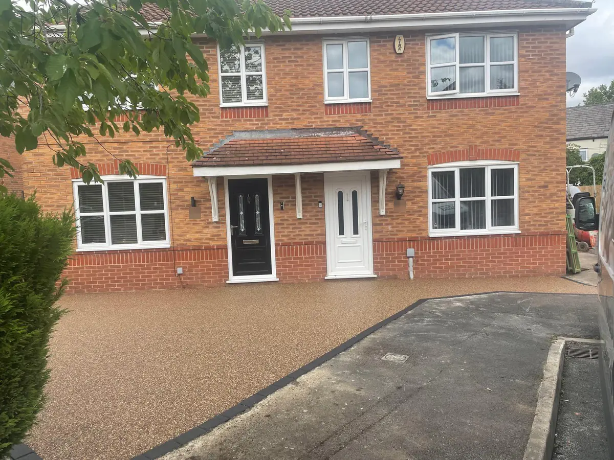 Golden Pea resin bound driveway with charcoal block border at a home in Hyde