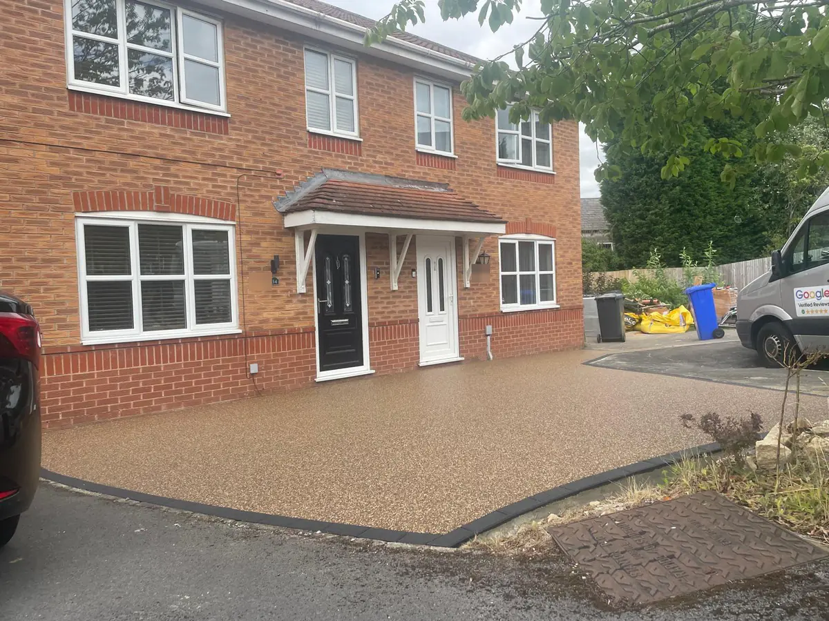 The finished Golden Pea resin driveway across the full width of the frontage